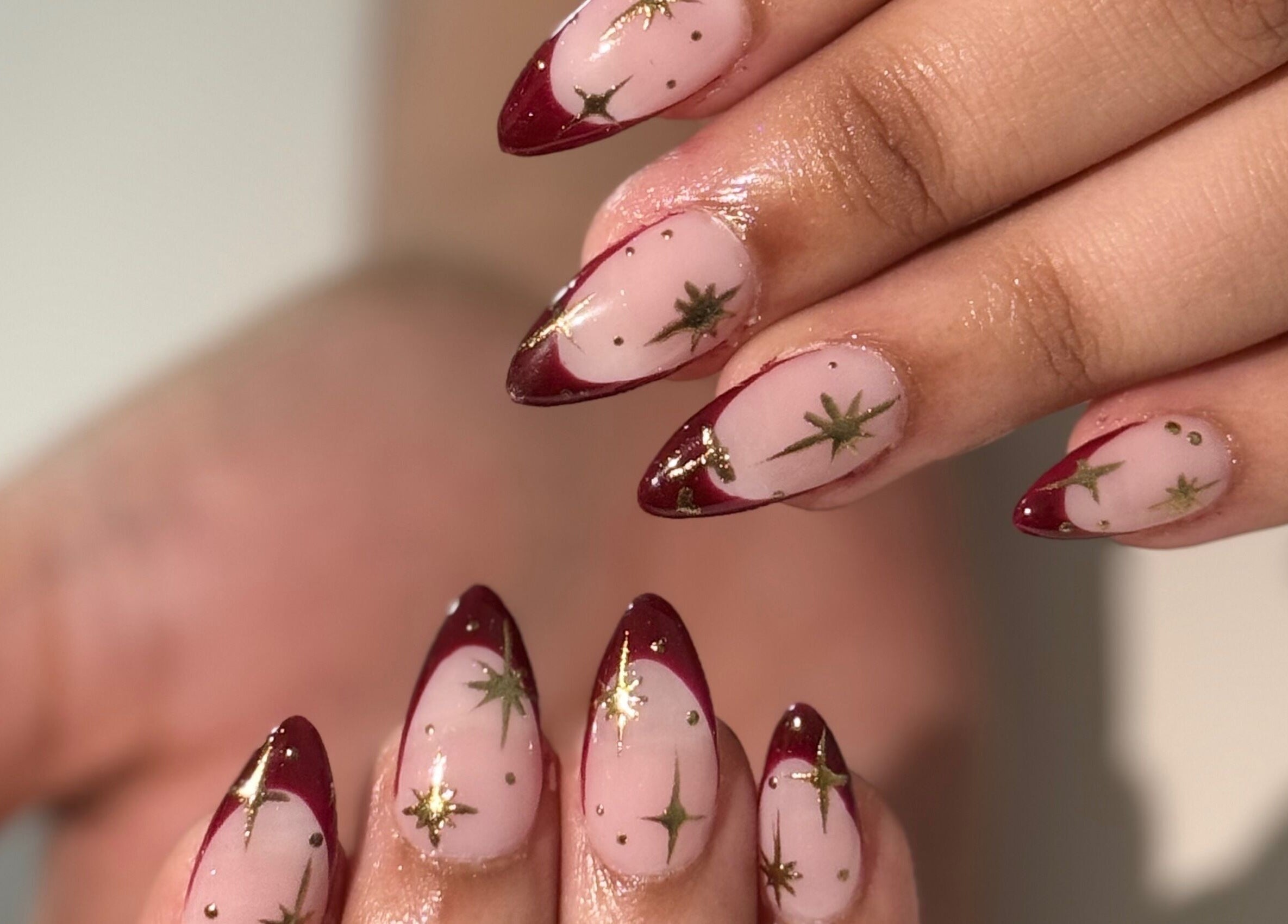 Elegant star-themed burgundy nail art from Nails by Teri, Queensburgh, Kwazulu-natal, ZA.