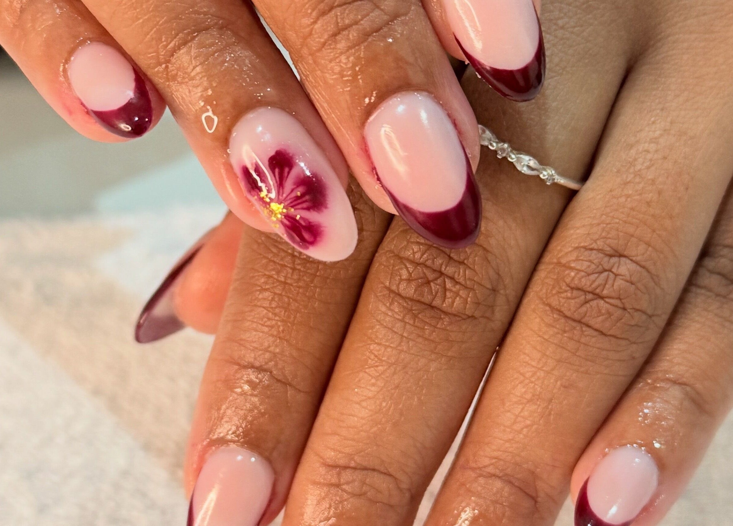 Elegant floral nail art by Nails by Teri, Queensburgh, Kwazulu-natal, ZA showcases intricate burgundy design.