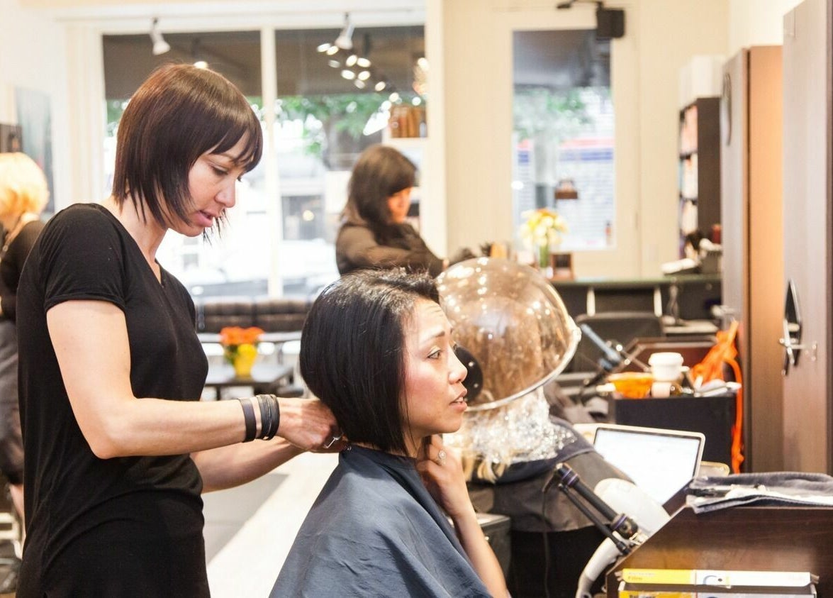 Stylist at ML Hair Studio in San Francisco, California, US expertly trims a client's hair.