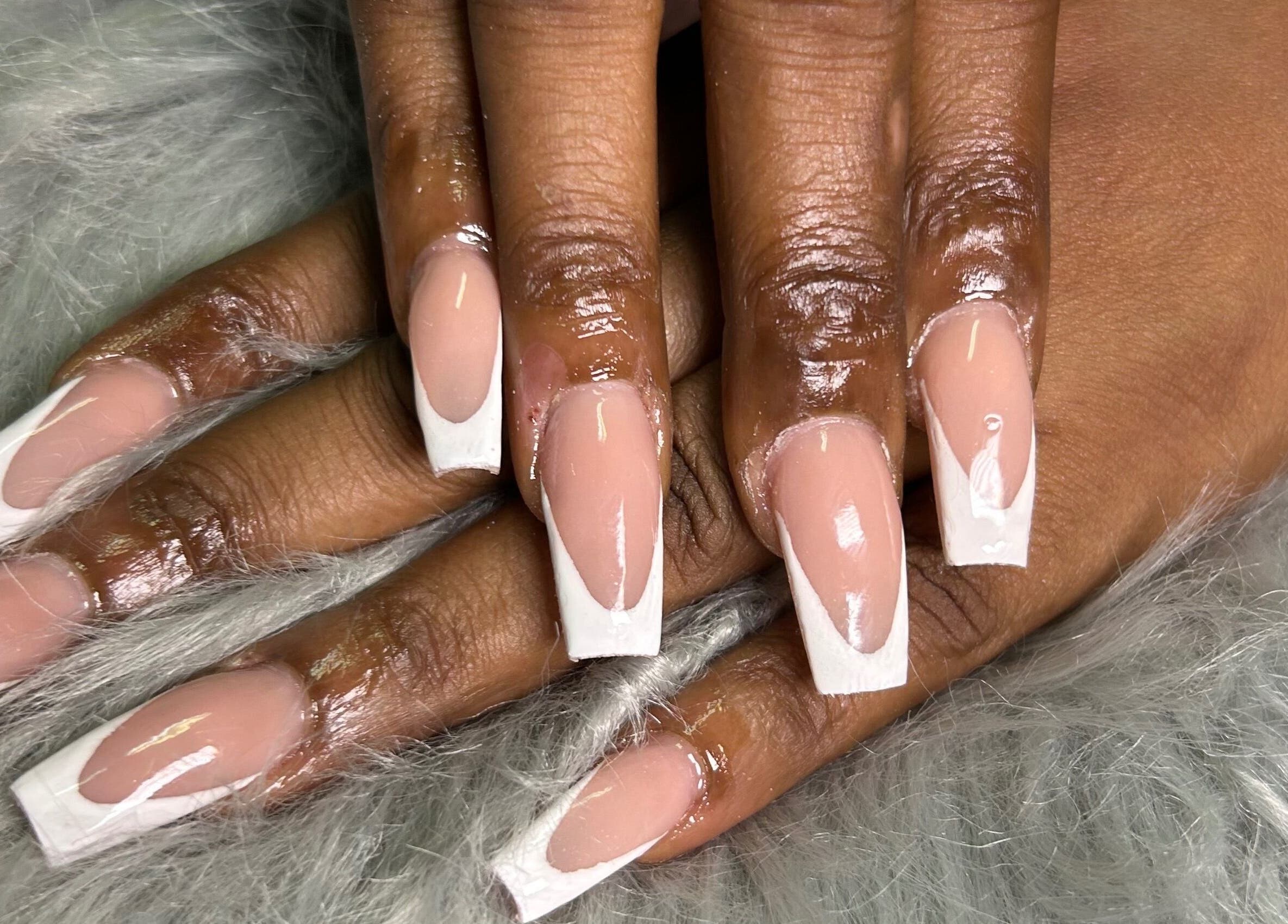 Glossy French manicured nails at She Buffed It, Nassau, New Providence, BS on soft fur.