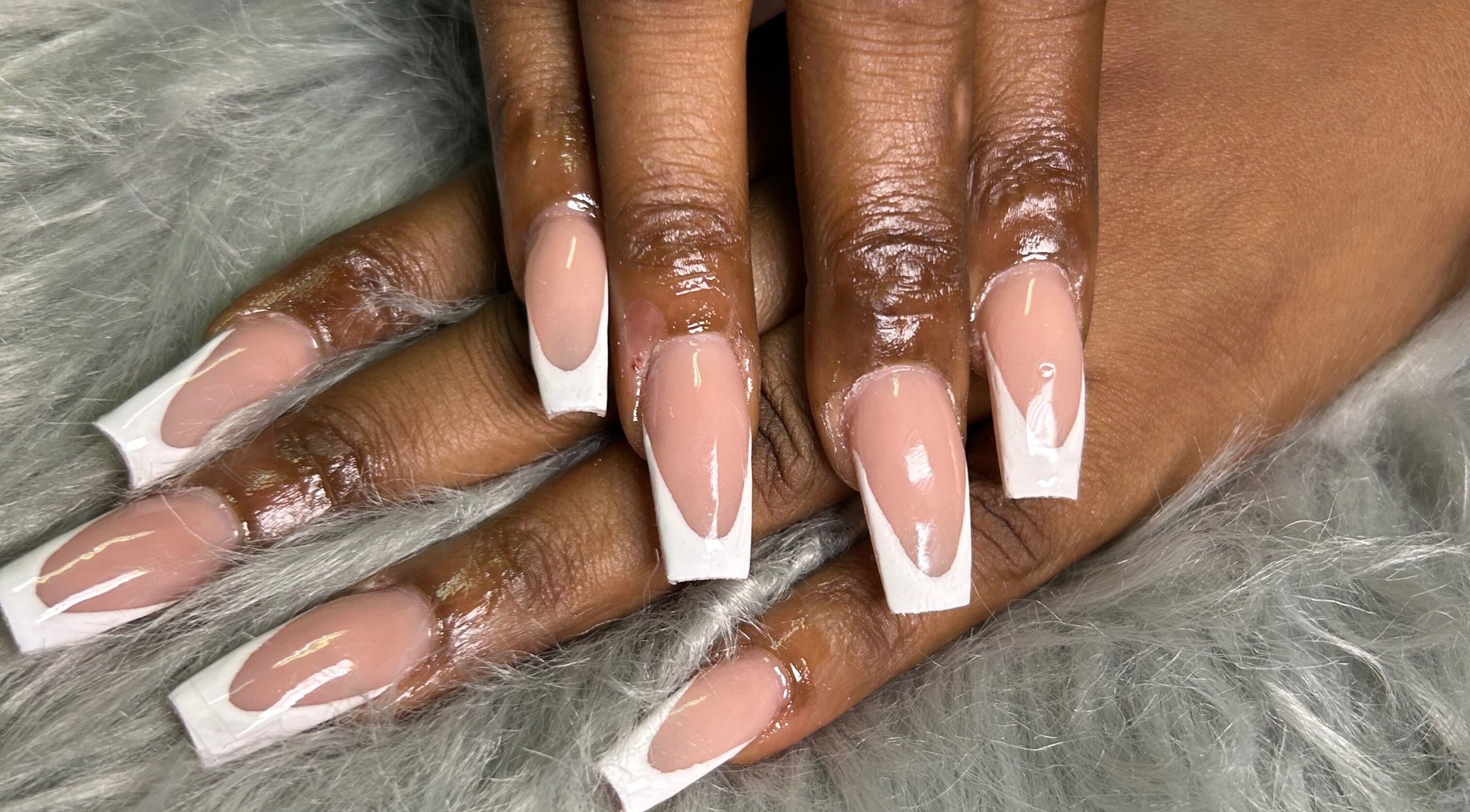 Glossy French manicured nails at She Buffed It, Nassau, New Providence, BS on soft fur.