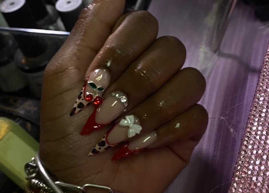 Intricate nail art design at She Buffed It in Nassau, New Providence, BS, showcasing unique embellishments.