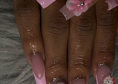 Elegant pink floral nail art at She Buffed It, Nassau, New Providence, BS, showcasing intricate designs.