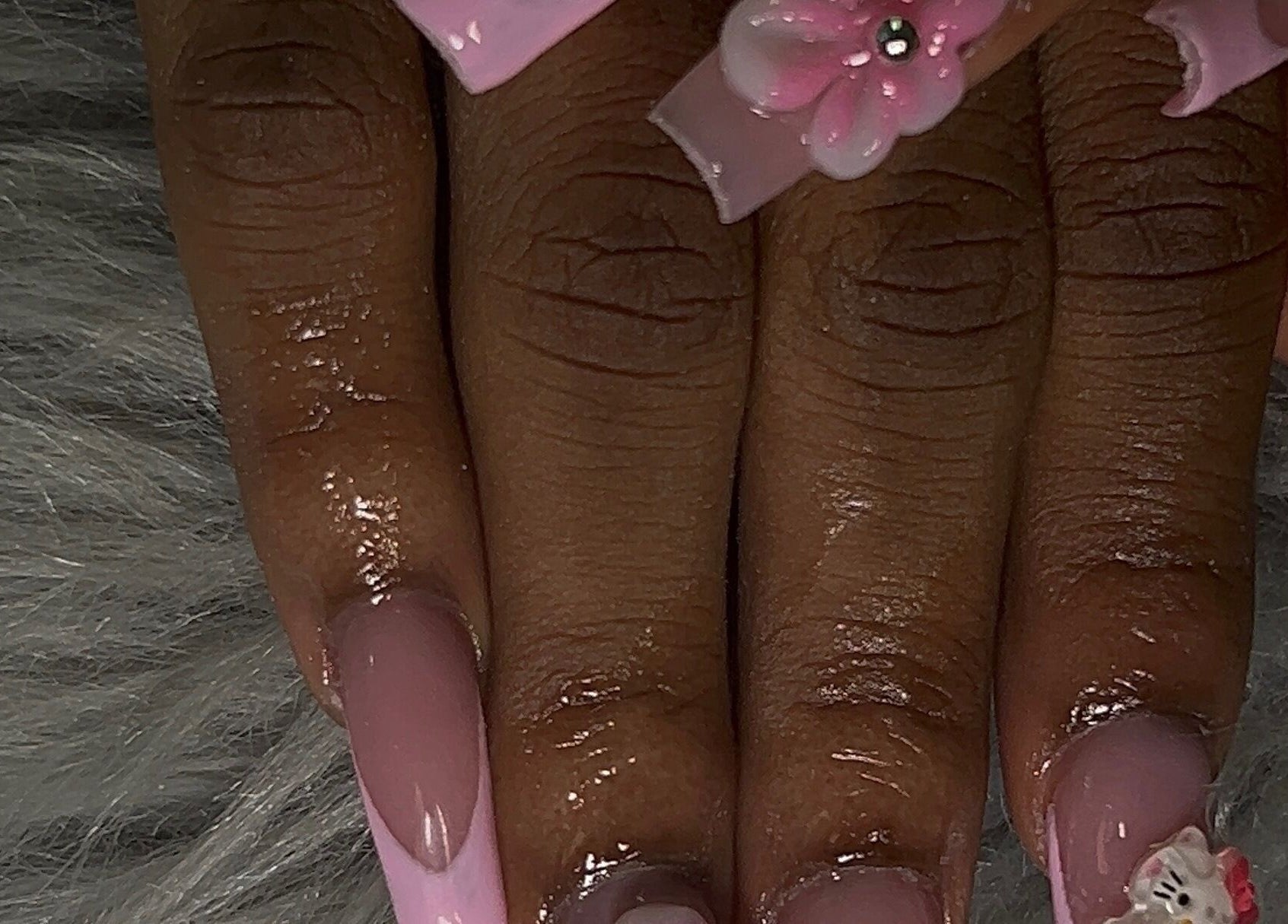 Elegant pink floral nail art at She Buffed It, Nassau, New Providence, BS, showcasing intricate designs.