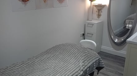 Cozy treatment room at Holisticlisa, Douglas, Onchan, IM, featuring a plush massage bed and calming decor.