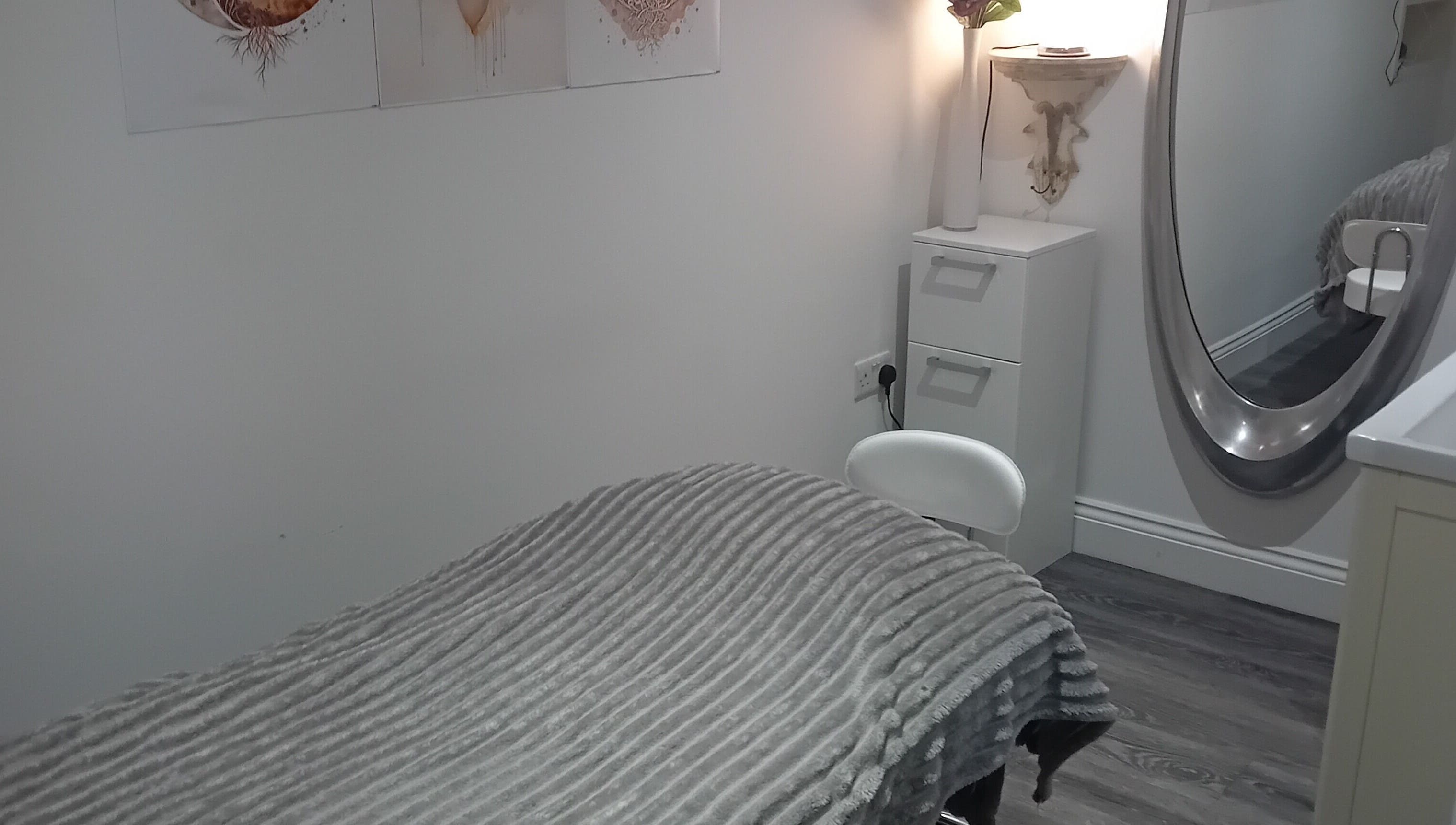 Tranquil treatment room at Holisticlisa, Douglas, Onchan, IM, with cozy decor and soft lighting.