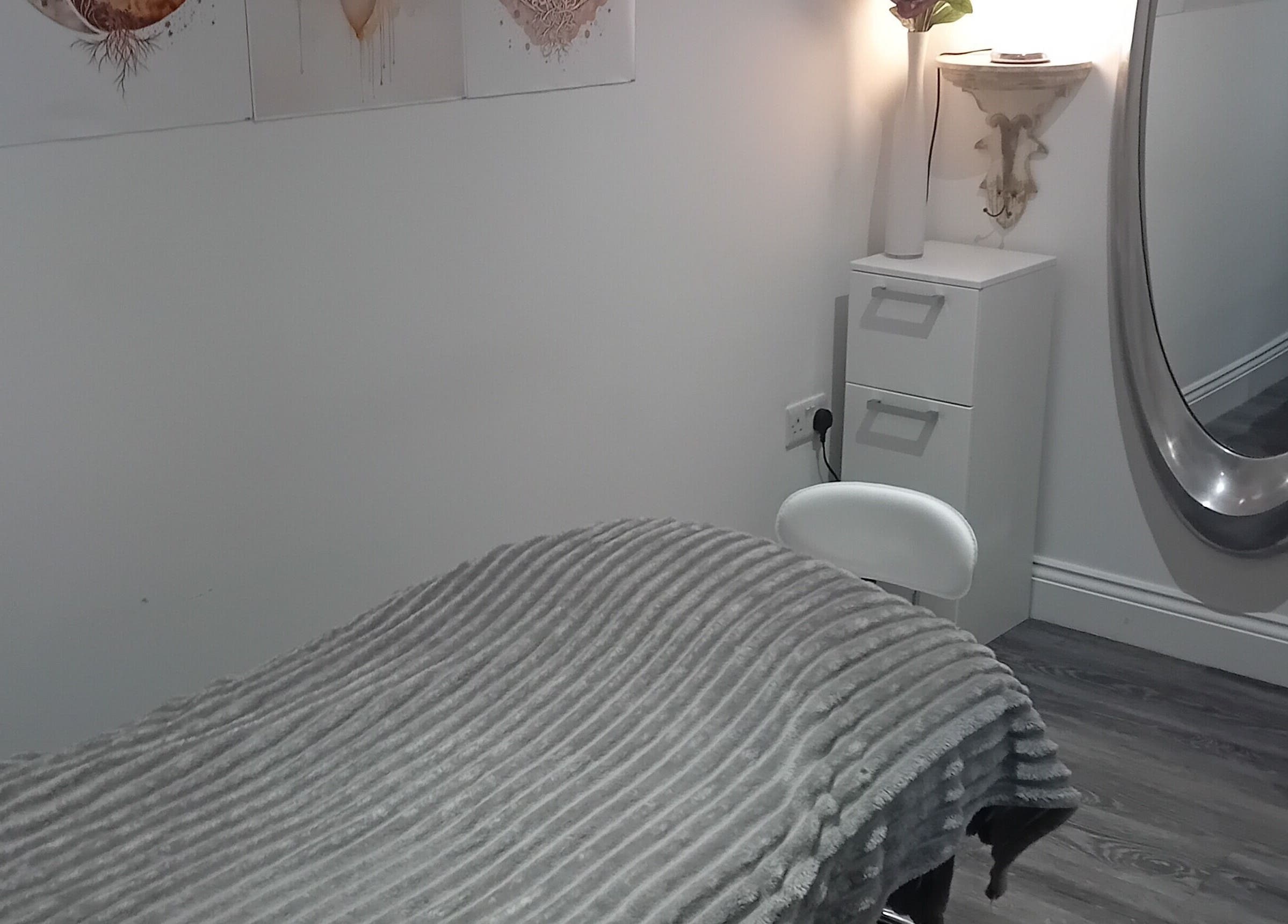 Tranquil treatment room at Holisticlisa, Douglas, Onchan, IM, with cozy decor and soft lighting.