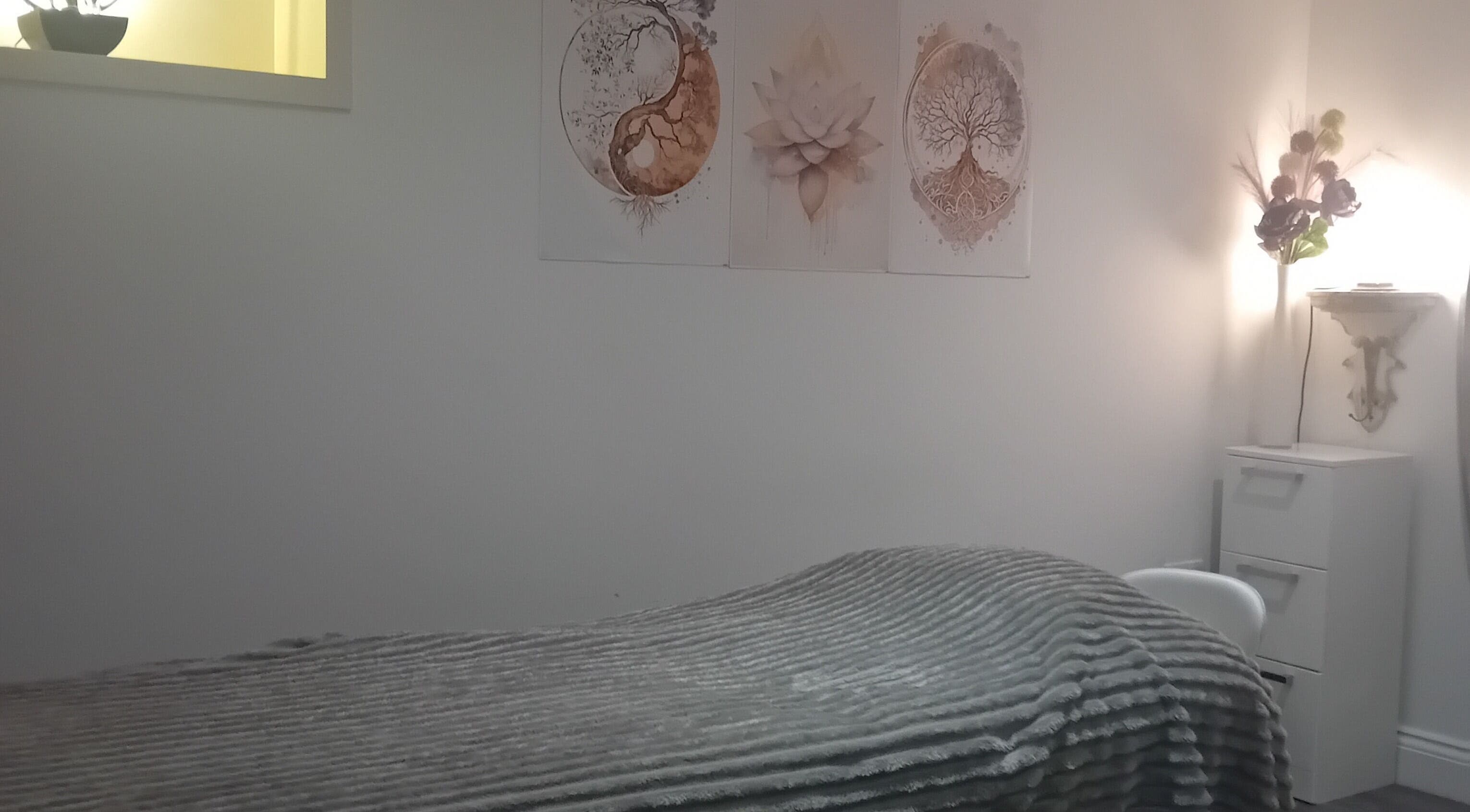 Cozy treatment room at Holisticlisa in Douglas, Onchan, IM with soft lighting and calming decor.