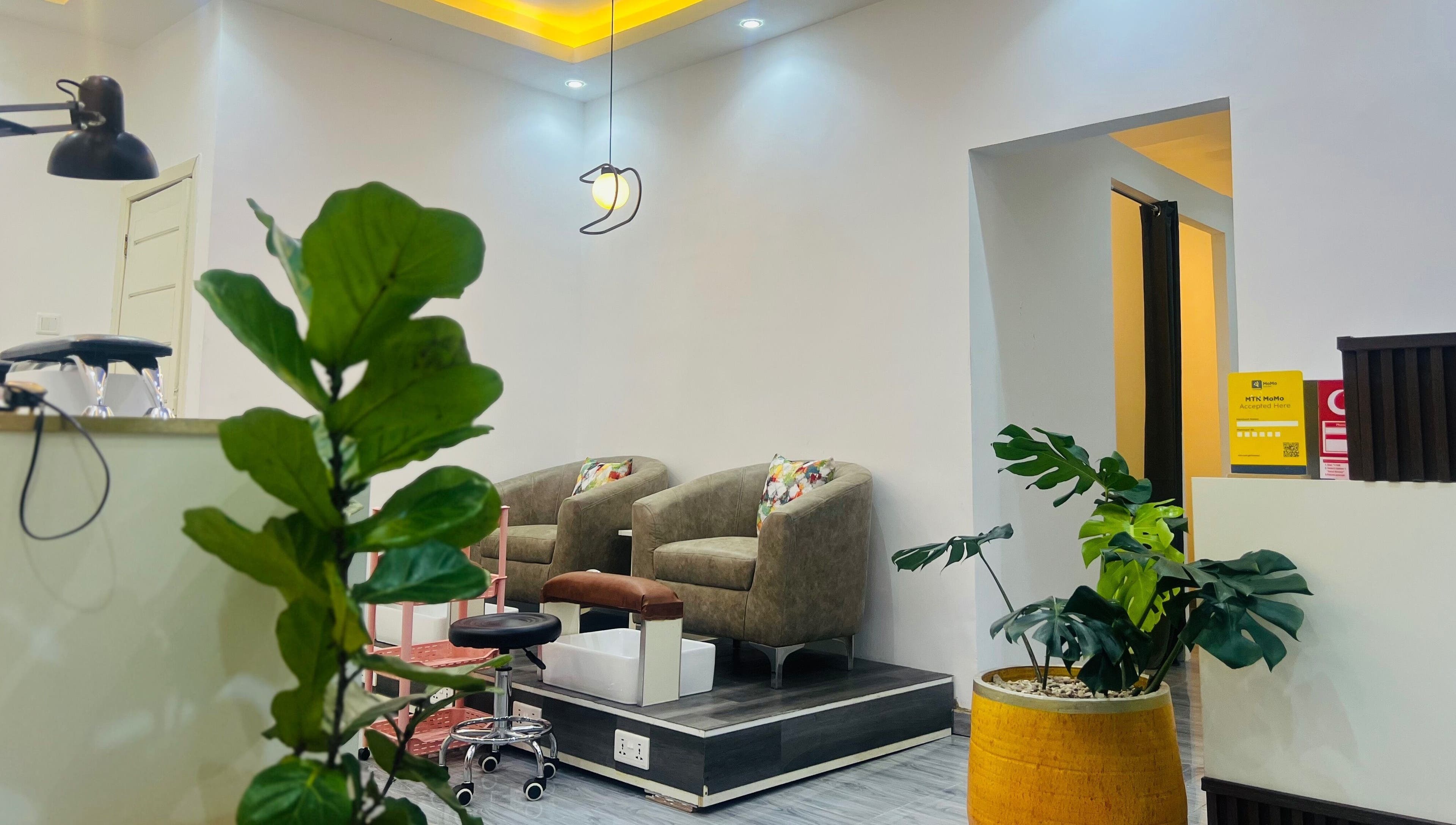Stylish waiting area at Ronexe Beauty Hub in Greater Accra Region, featuring plush chairs and vibrant decor.