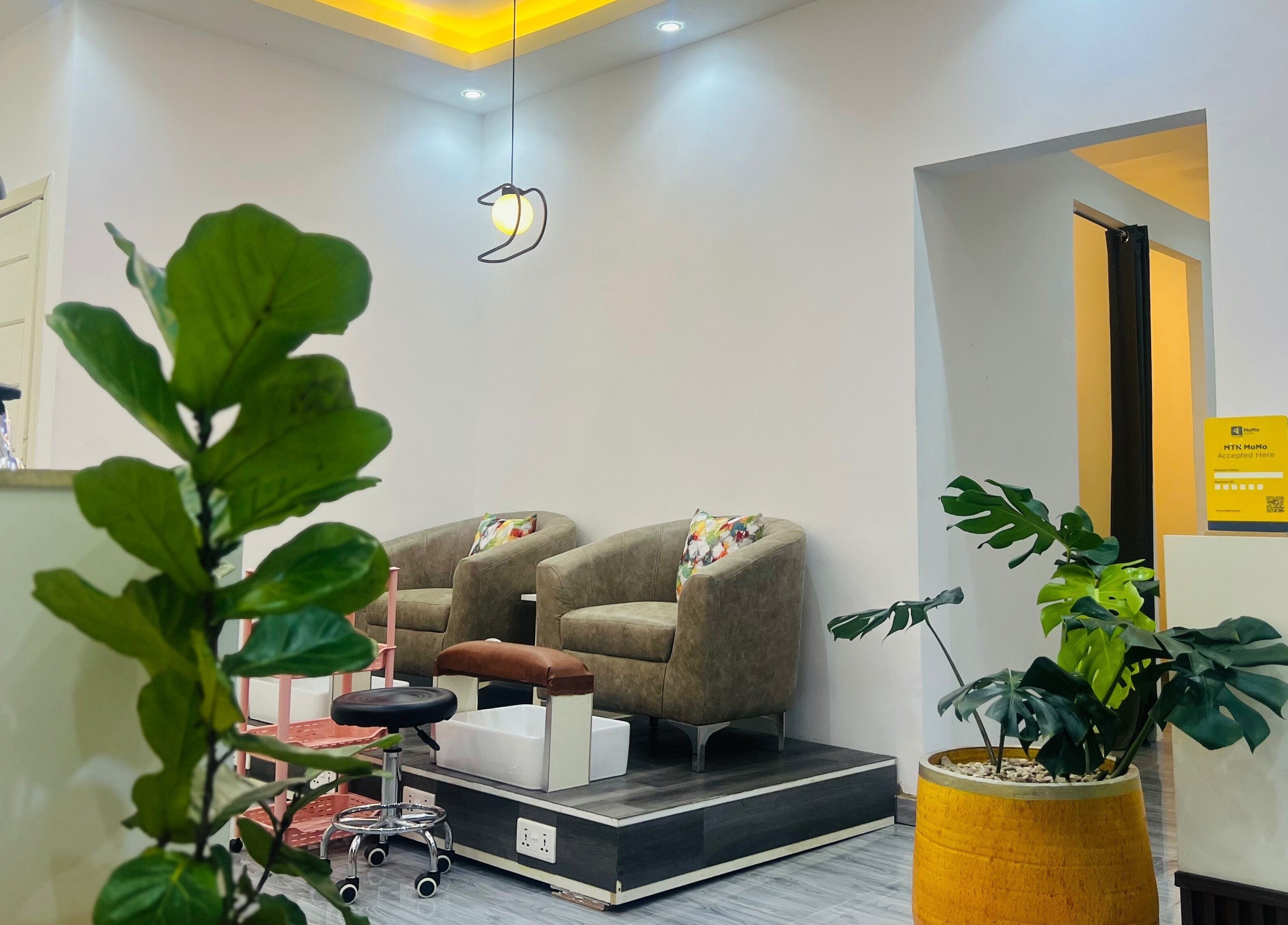 Stylish waiting area at Ronexe Beauty Hub in Greater Accra Region, featuring plush chairs and vibrant decor.