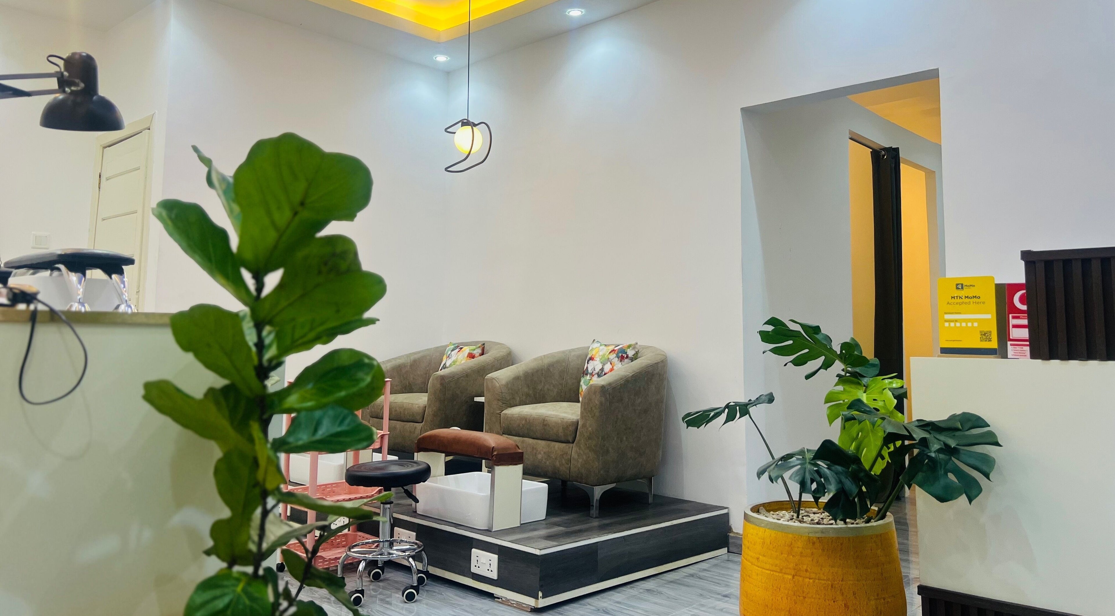 Stylish waiting area at Ronexe Beauty Hub in Greater Accra Region, featuring plush chairs and vibrant decor.