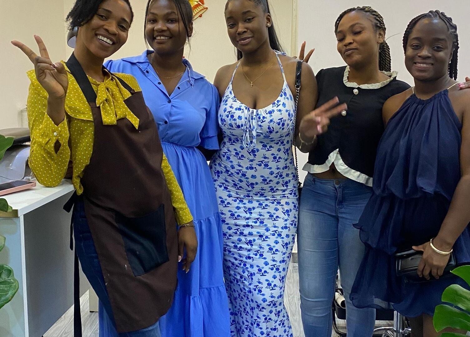 A cheerful group of five women at Ronexe Beauty Hub, Greater Accra Region, GH, showcasing a friendly atmosphere.