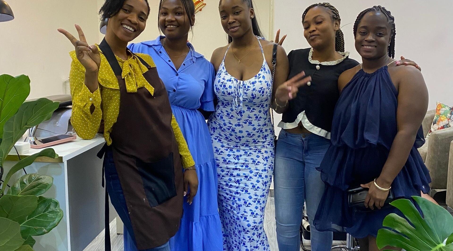 A cheerful group of five women at Ronexe Beauty Hub, Greater Accra Region, GH, showcasing a friendly atmosphere.