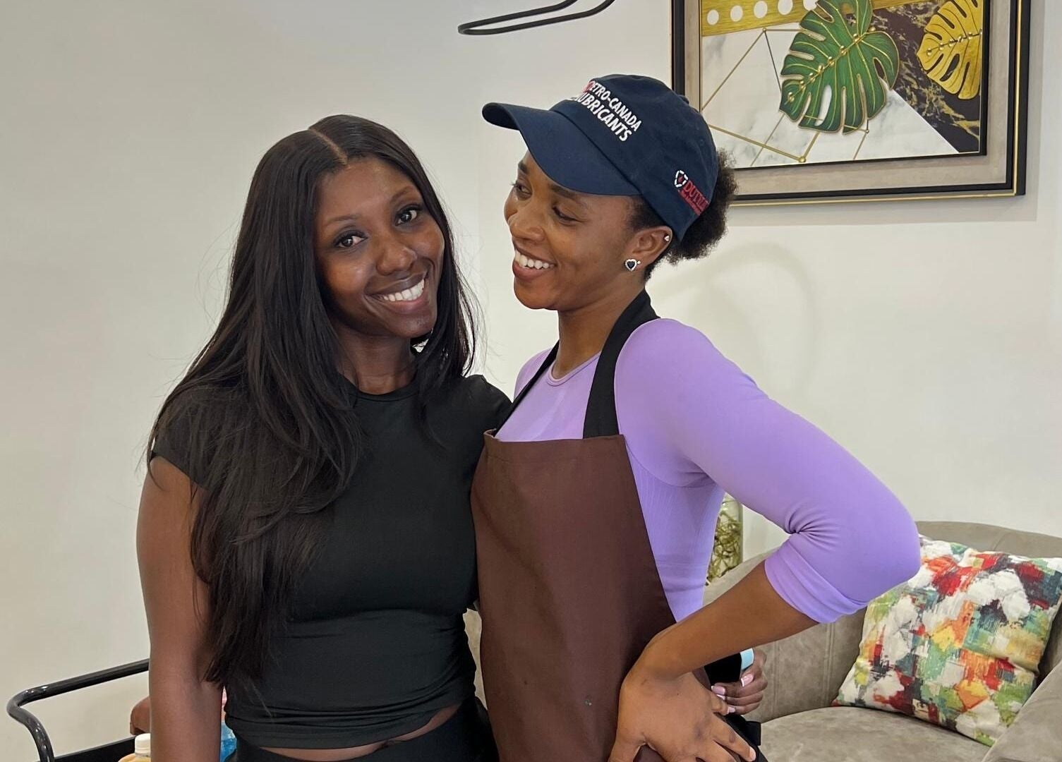 Two women smiling at Ronexe Beauty Hub in Greater Accra Region, GH, enhancing beauty and wellness together.