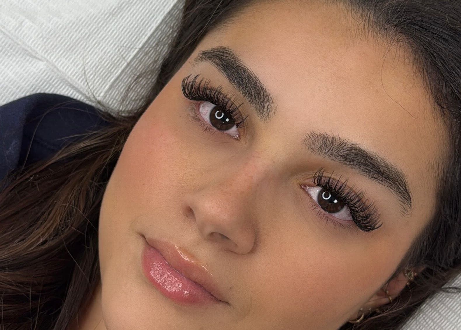 Close-up of woman with elegant eyelash extensions by Lashes By Alex in Laval, Québec, CA.