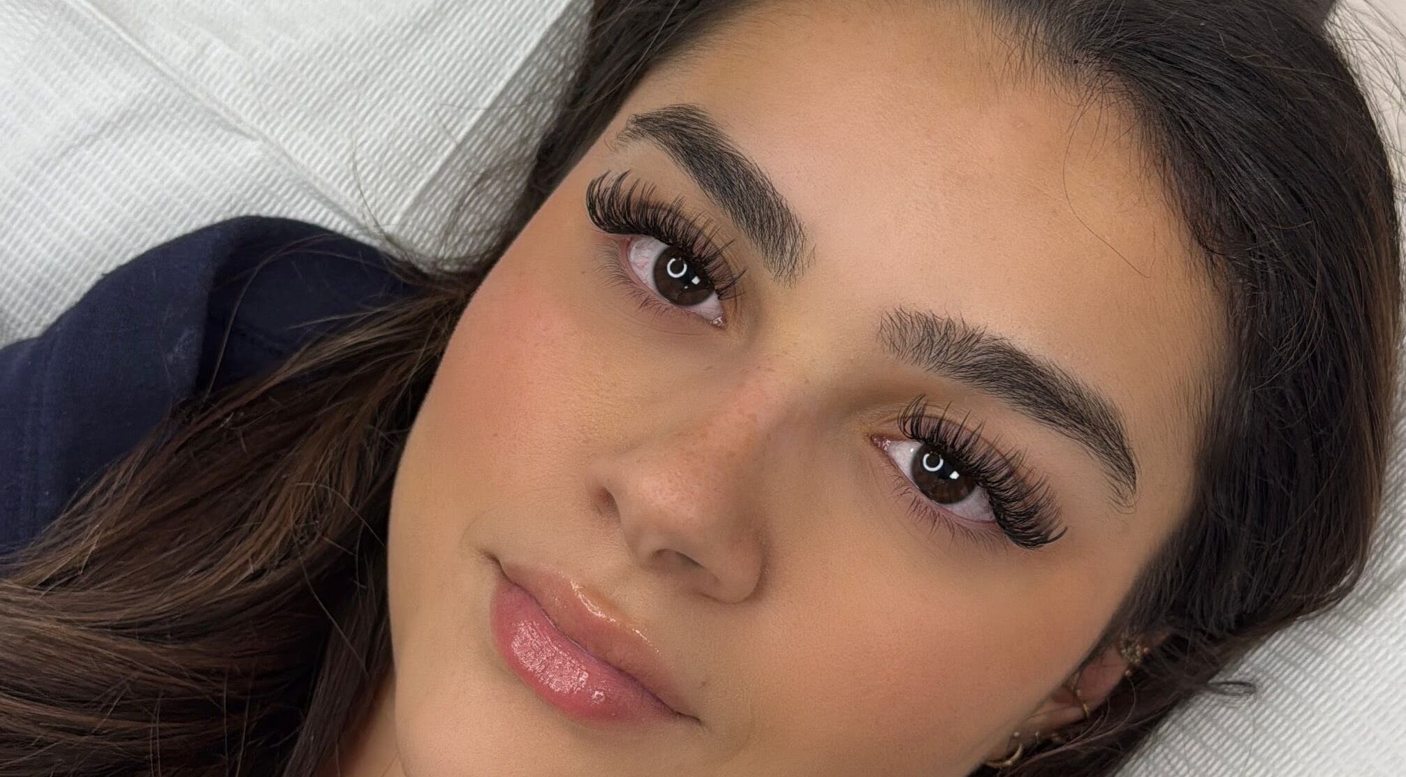 Close-up of woman with elegant eyelash extensions by Lashes By Alex in Laval, Québec, CA.