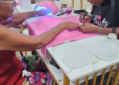 Client receiving a manicure at Xtra Touch Oasis in Scarborough, Tobago, TT, with focus on detailed care.