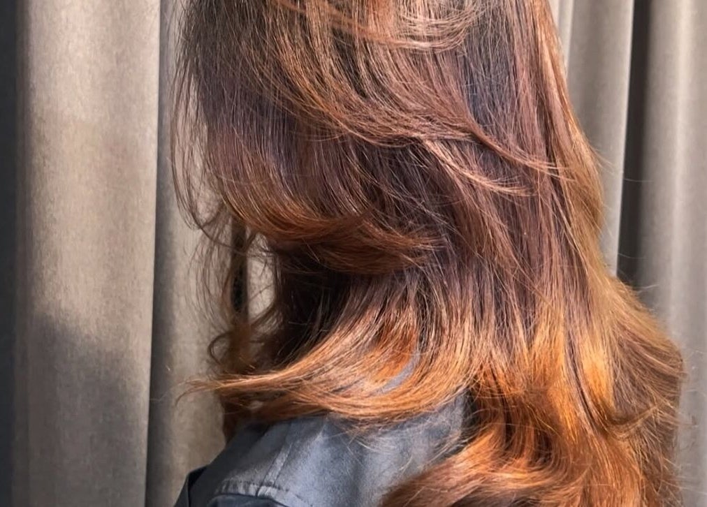 Elegant wavy hairstyle at Teera Hair Touch, Petaling Jaya, Selangor, MY, showcasing vibrant color and shine.