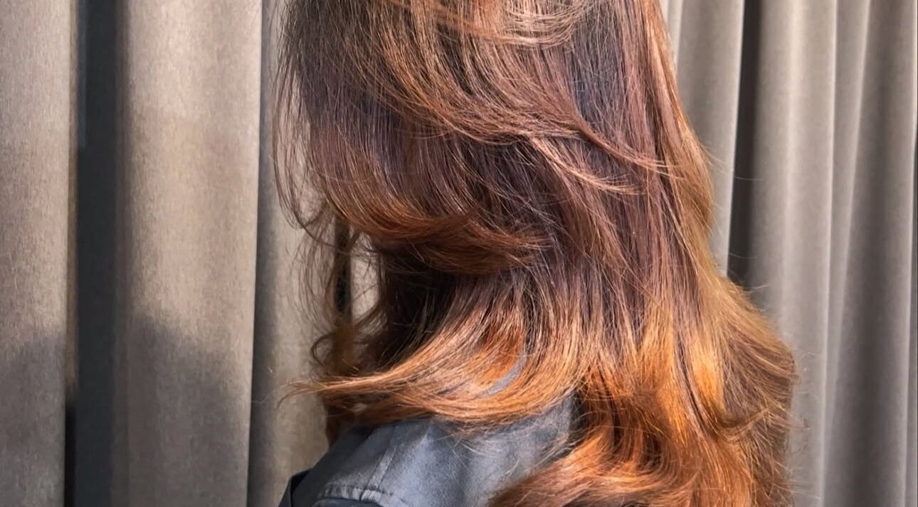 Elegant wavy hairstyle at Teera Hair Touch, Petaling Jaya, Selangor, MY, showcasing vibrant color and shine.