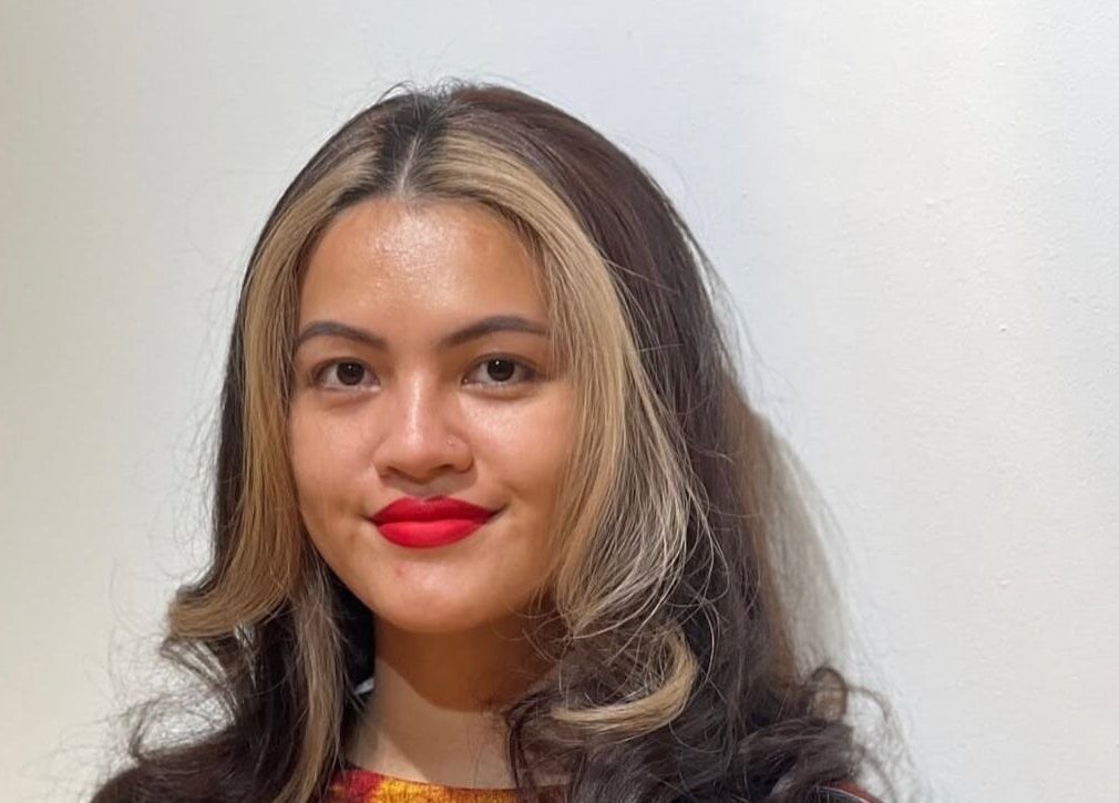 Smiling woman with stylish curls at Teera Hair Touch, Petaling Jaya, Selangor, MY.