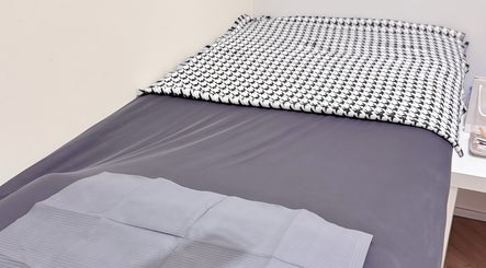 Cozy treatment bed at LynnStudiosg, Singapore, Singapore, SG, ready for a relaxing wellness session.