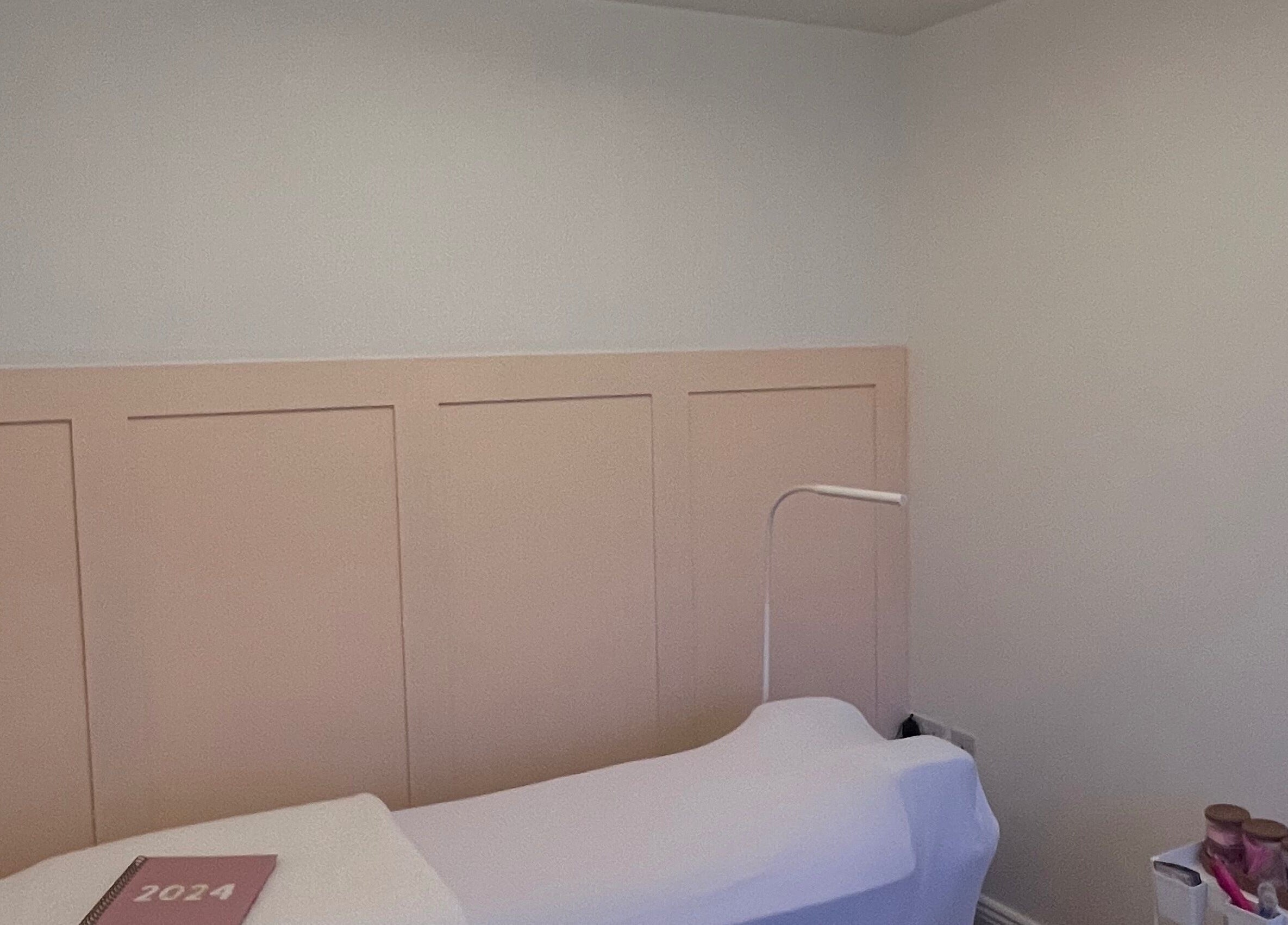 Tranquil treatment room at LSM Beauty, Whitehaven, England, GB, featuring a cozy bed and soothing decor.