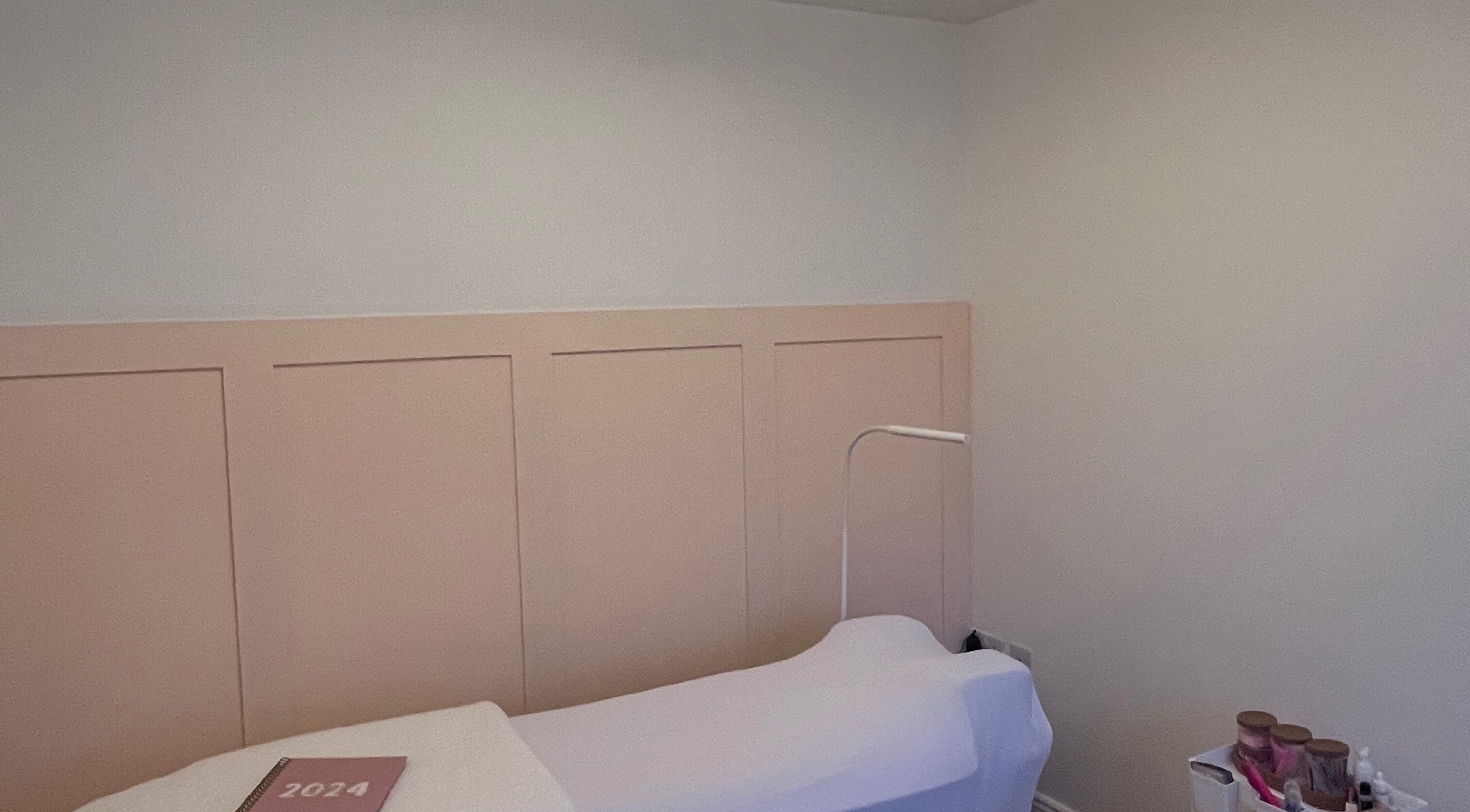 Tranquil treatment room at LSM Beauty, Whitehaven, England, GB, featuring a cozy bed and soothing decor.