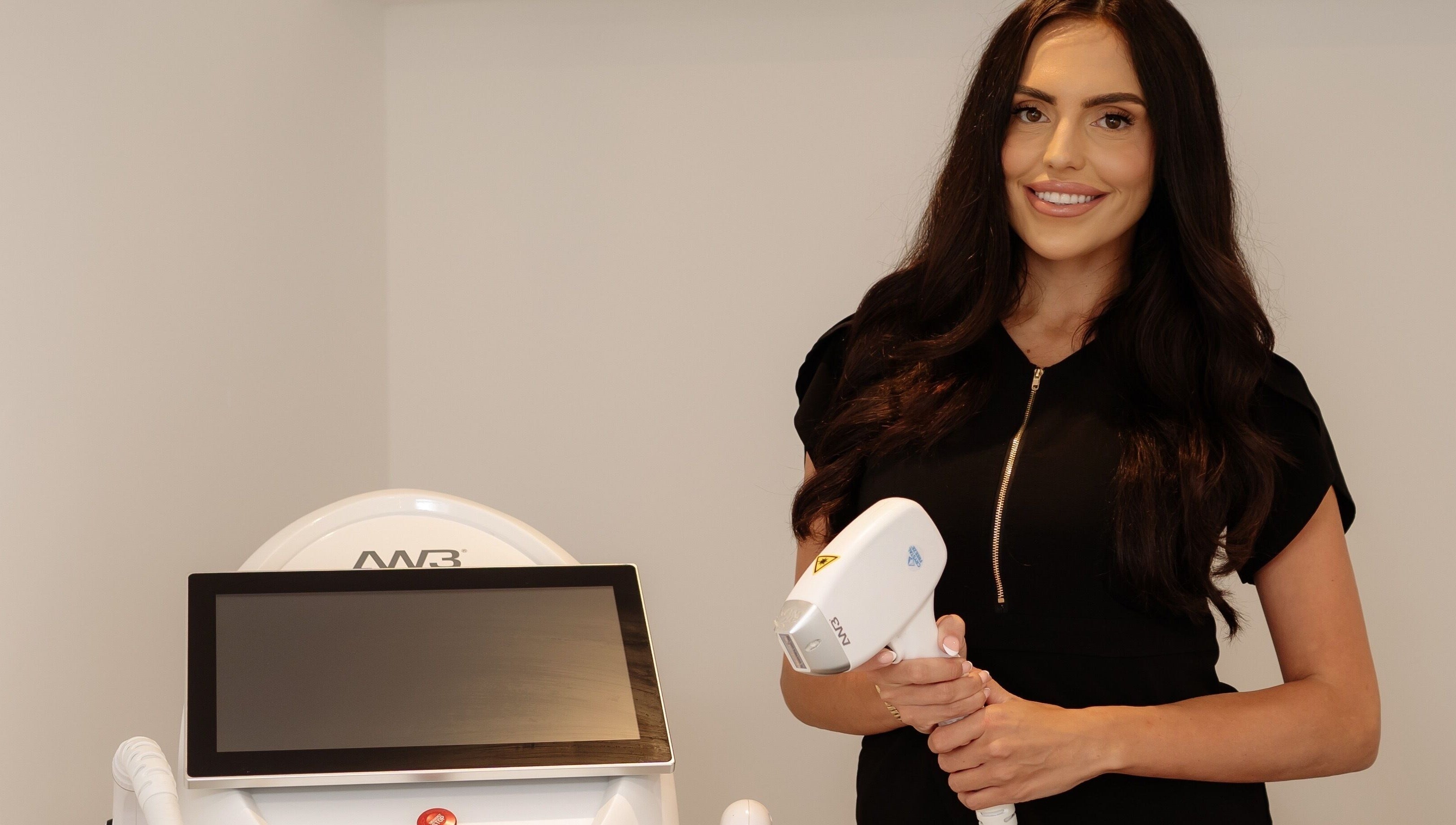 Professional at Radiance Laser Studio in Aberdeen, Scotland, GB holding laser equipment, ready for treatment.