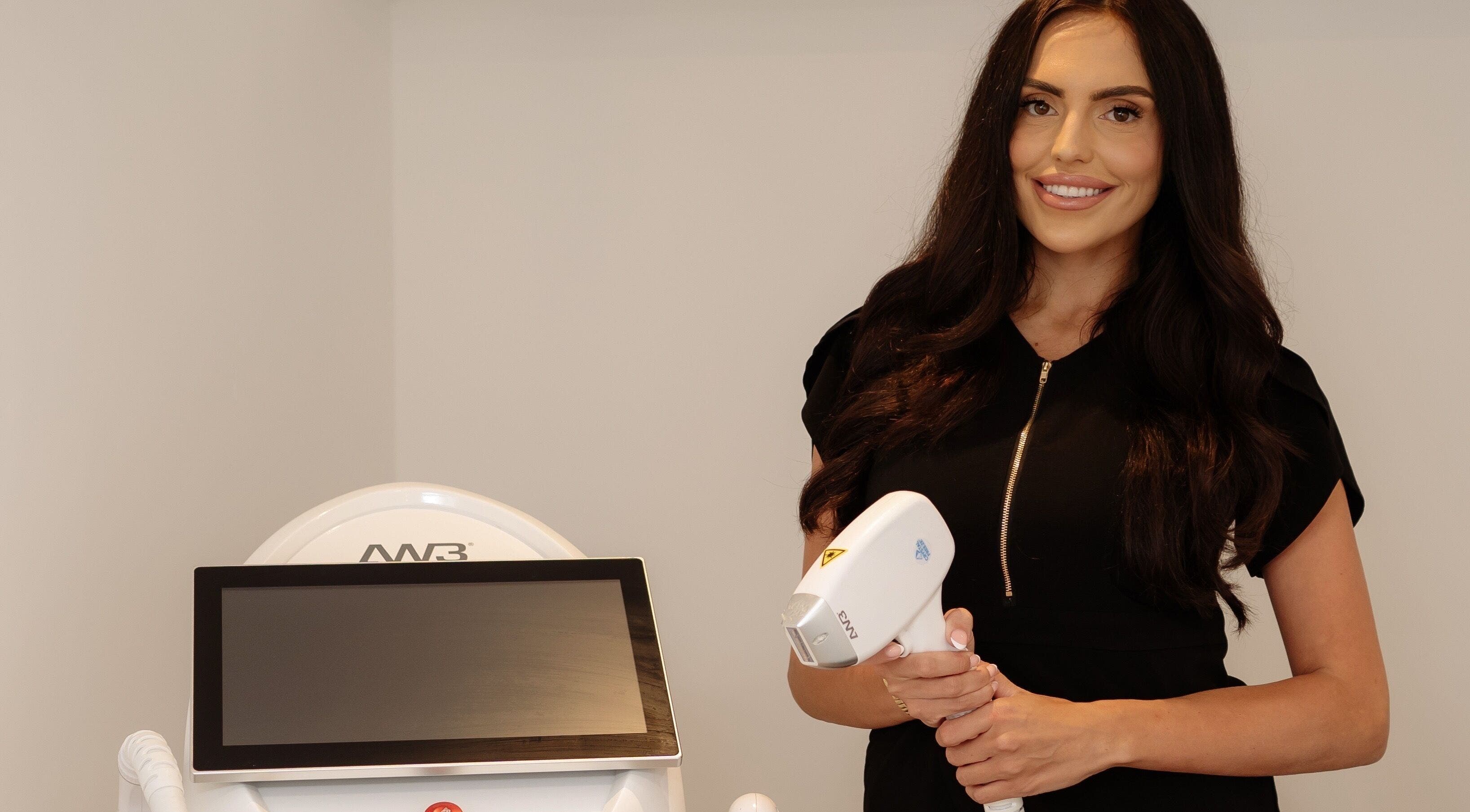 Professional at Radiance Laser Studio in Aberdeen, Scotland, GB holding laser equipment, ready for treatment.