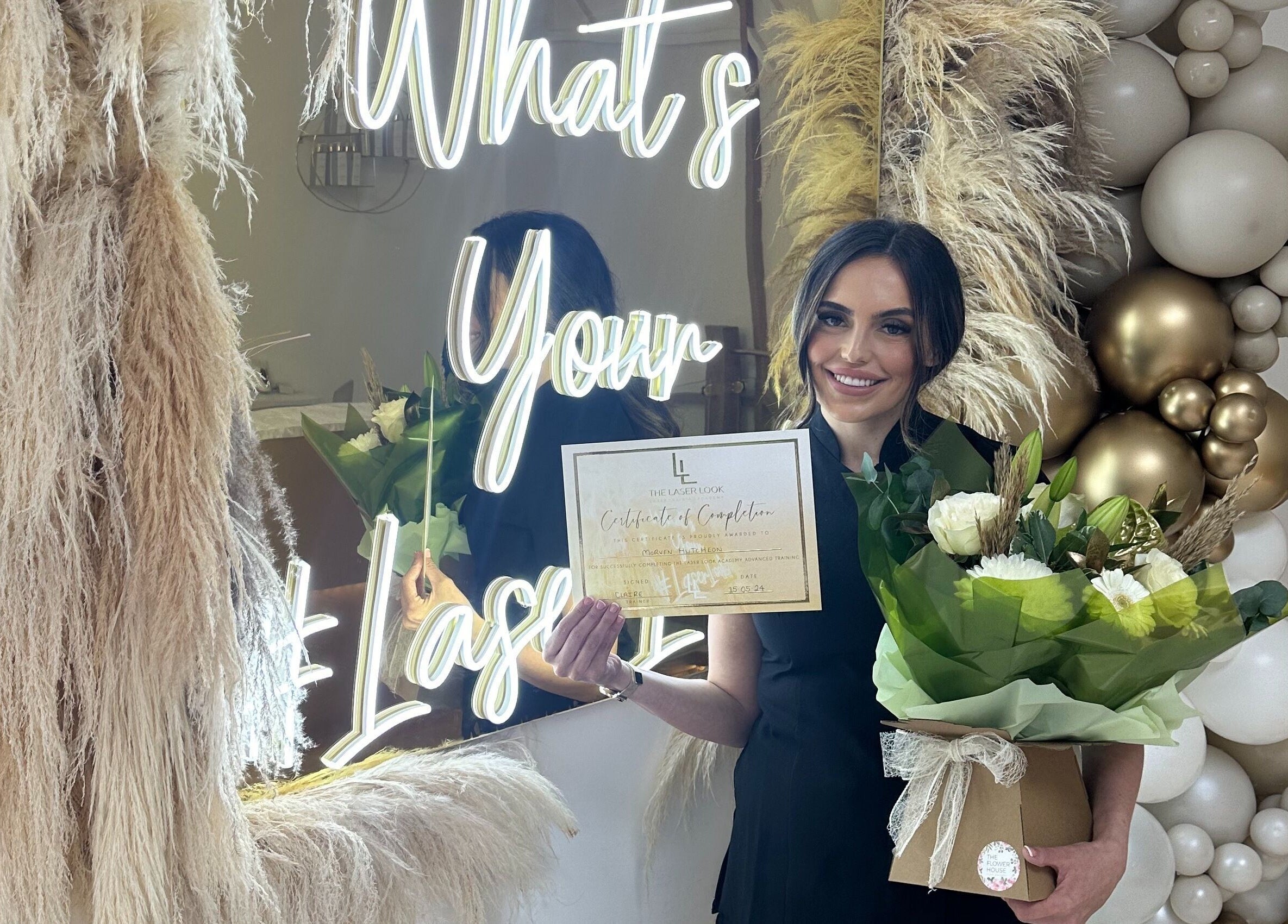 Proud staff at Radiance Laser Studio, Aberdeen, Scotland, GB, displays certificate and flowers.