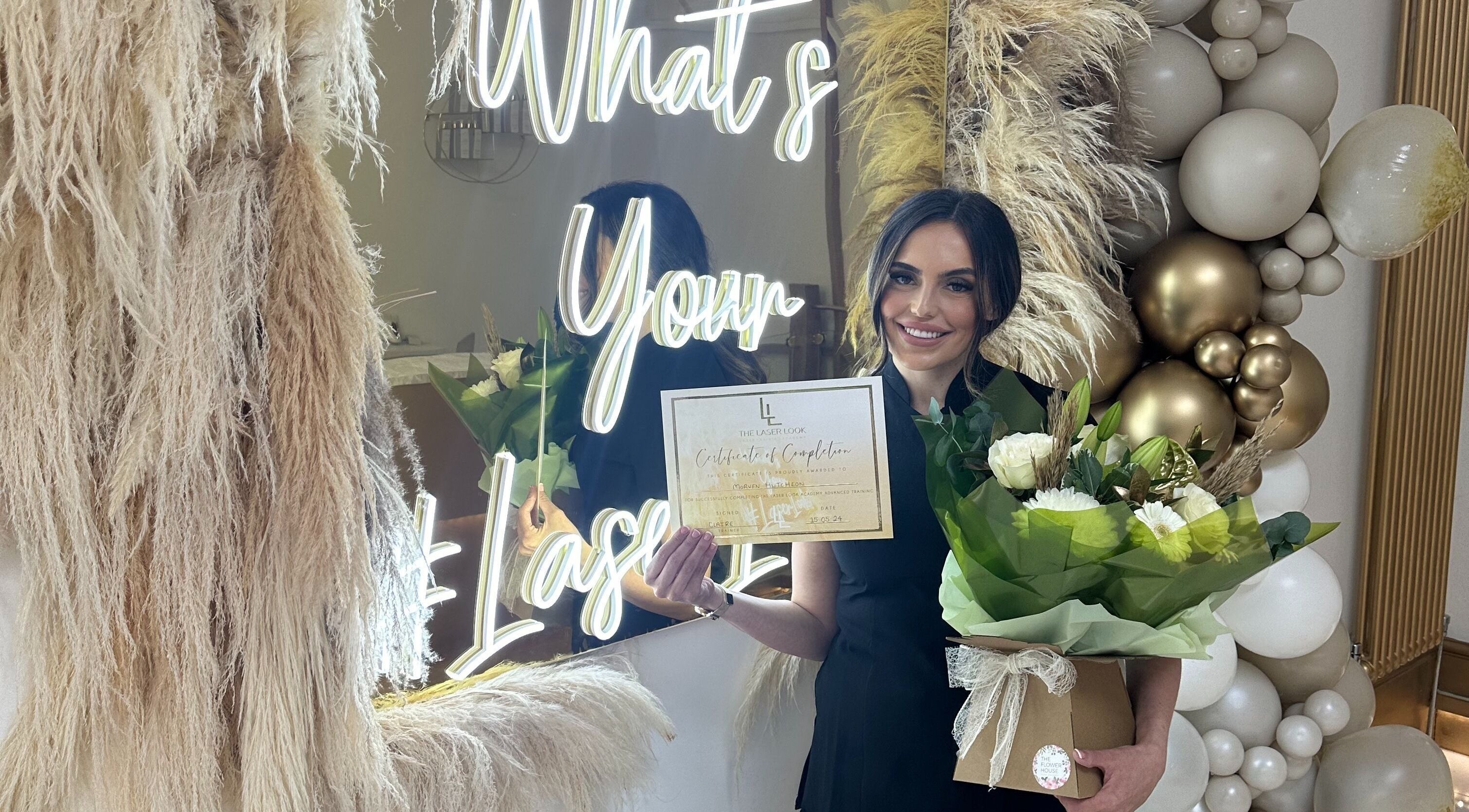 Proud staff at Radiance Laser Studio, Aberdeen, Scotland, GB, displays certificate and flowers.