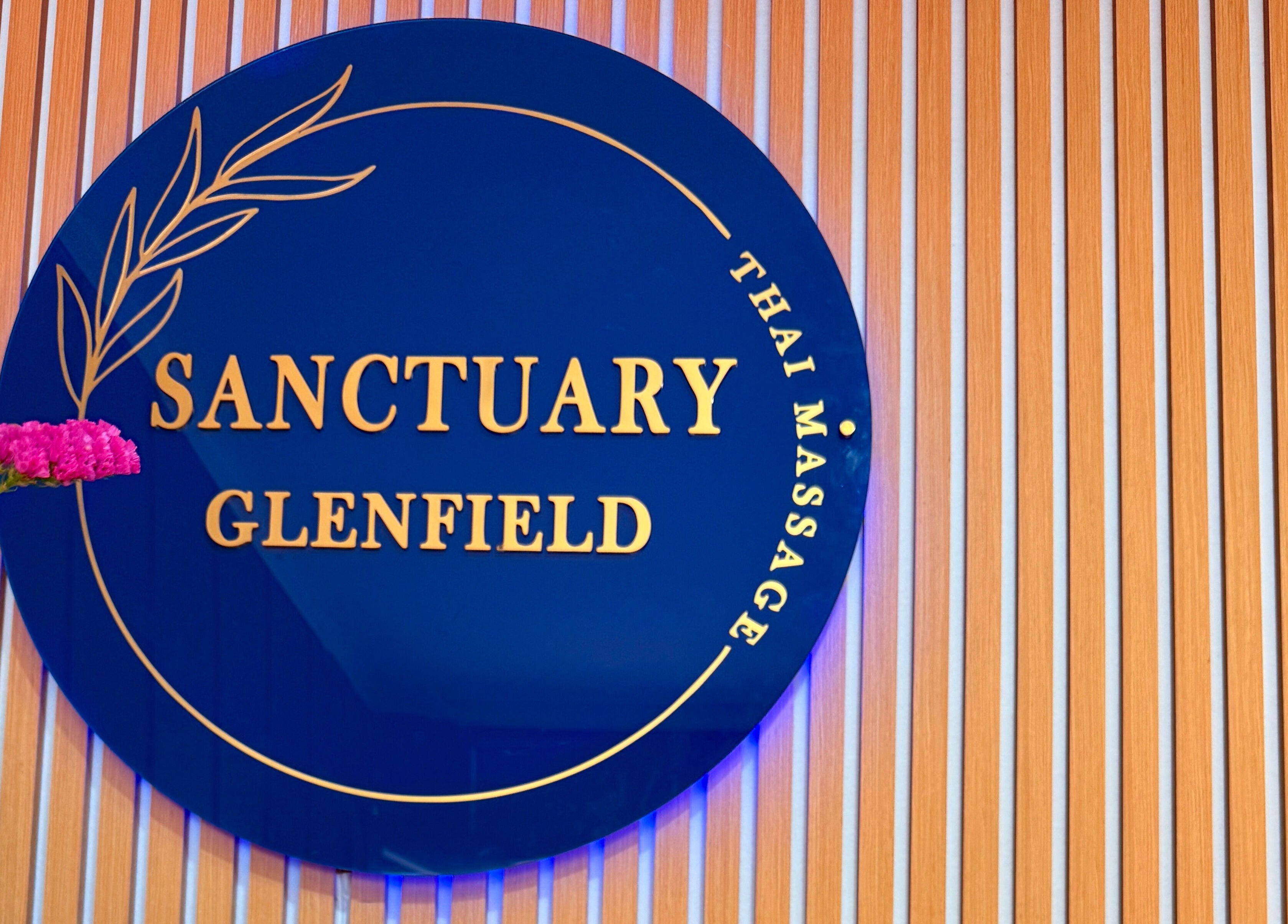 Elegant Sanctuary Glenfield sign with floral decor, Auckland, NZ. Embodying beauty and wellness.