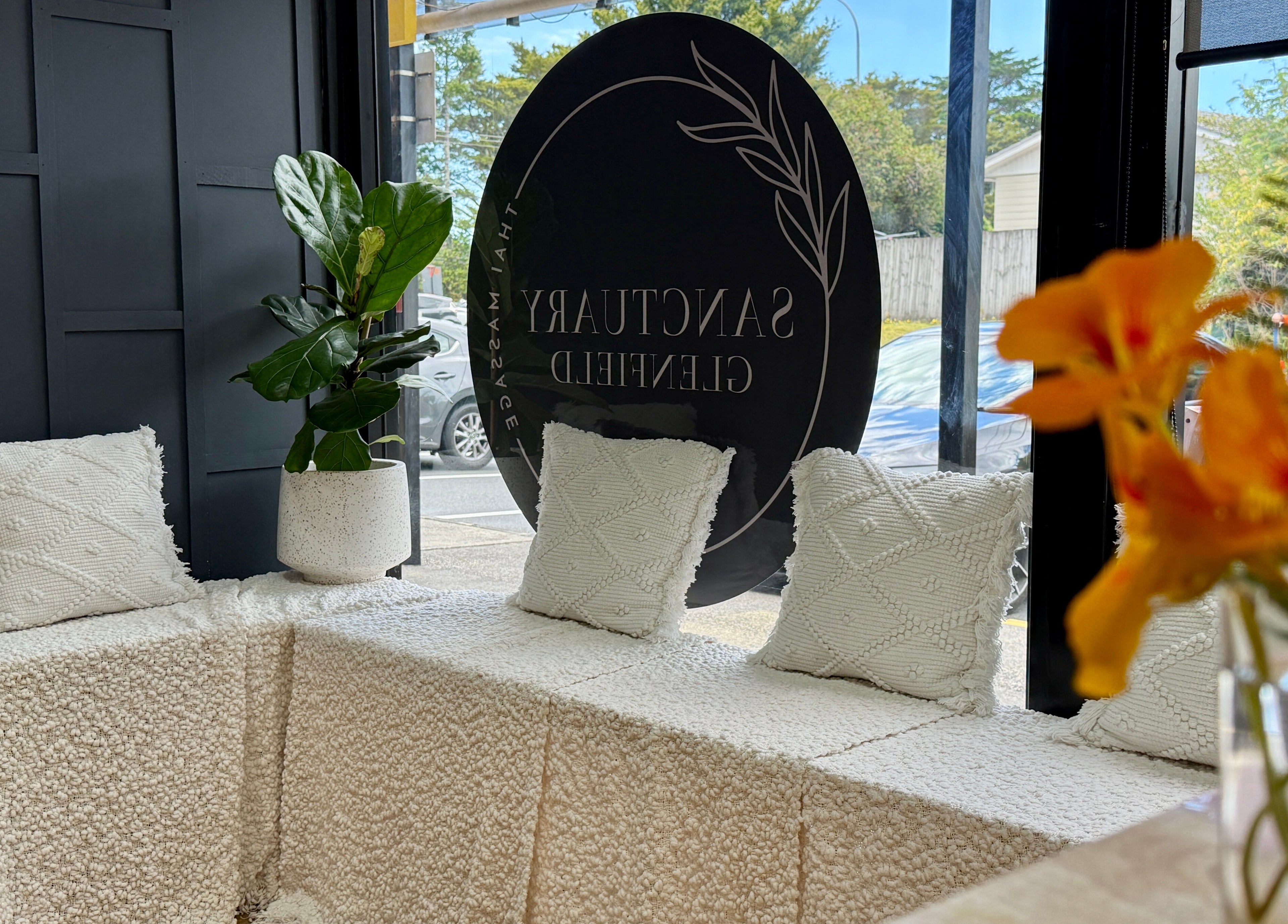 Cozy seating at Sanctuary Glenfield, Auckland, NZ with lush plants and elegant decor.