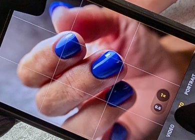 Close-up of vibrant blue nails at Andreas Hands and Tans, Stevenage, England, GB.