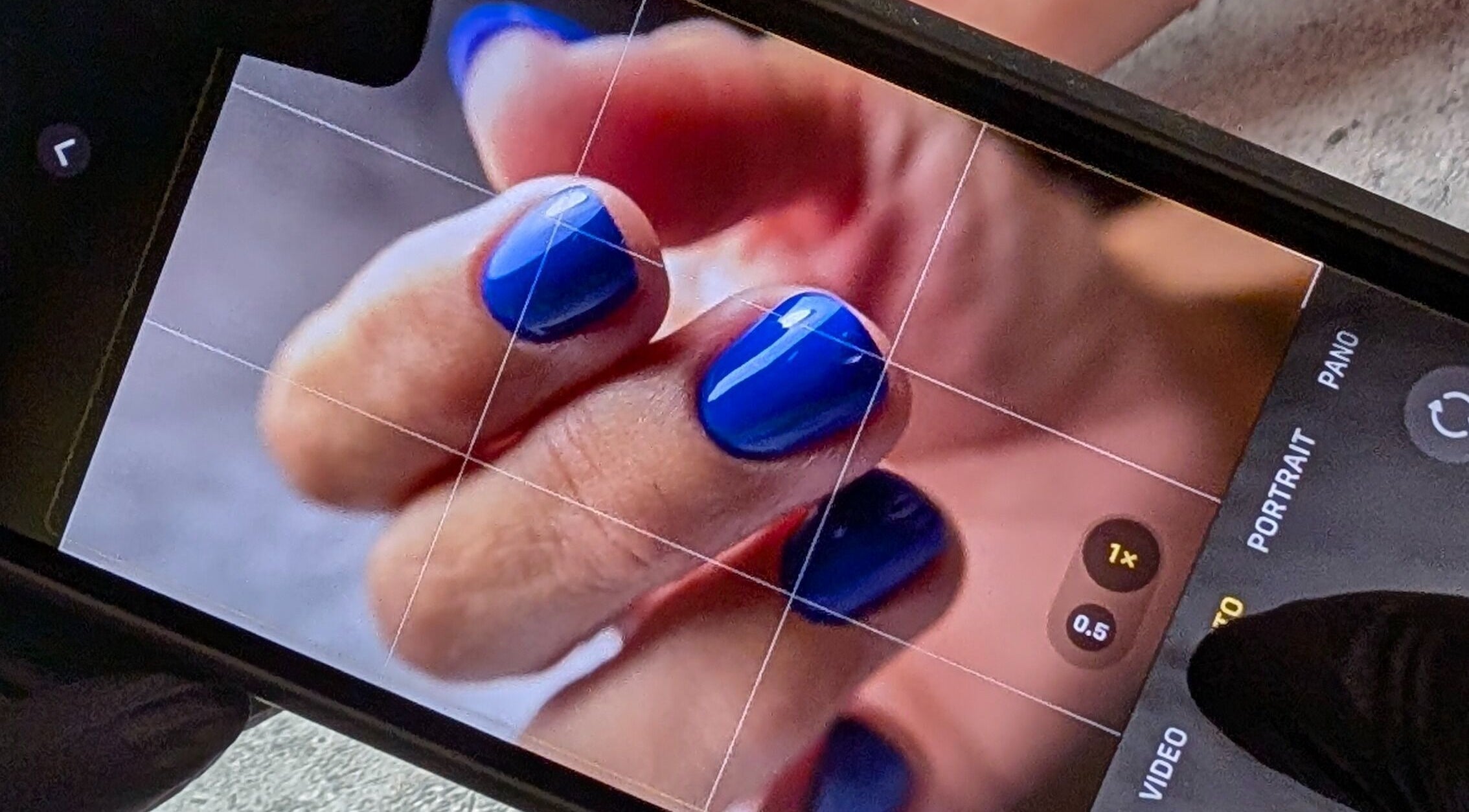Close-up of vibrant blue nails at Andreas Hands and Tans, Stevenage, England, GB.