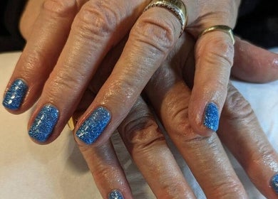 Blue glitter manicure at Andreas Hands and Tans in Stevenage, England, GB, showcasing stylish nail care.