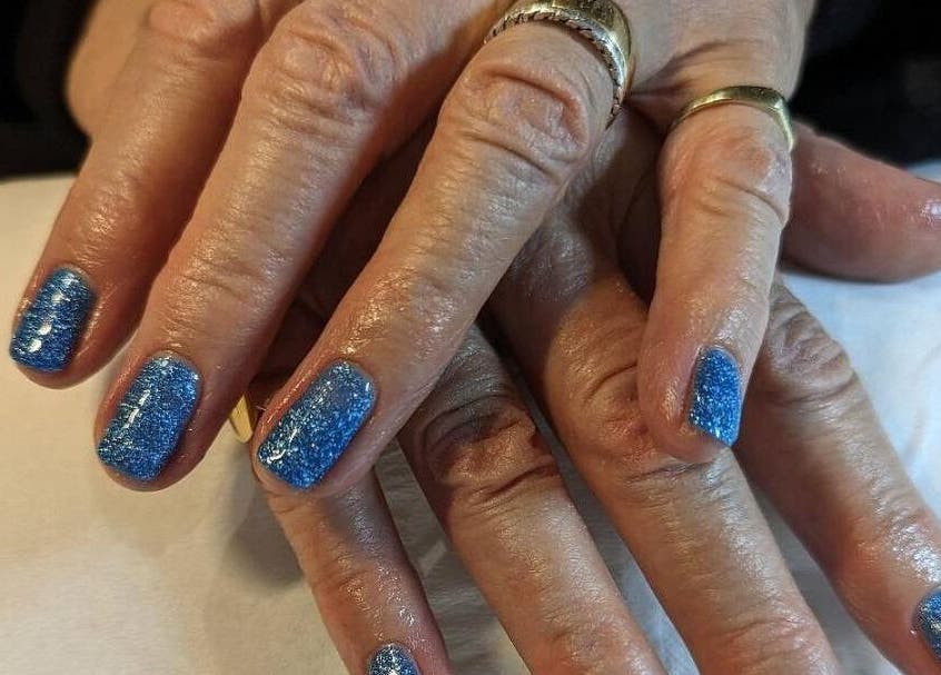 Blue glitter manicure at Andreas Hands and Tans in Stevenage, England, GB, showcasing stylish nail care.