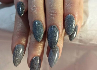 Elegant glitter nails at Andreas Hands and Tans in Stevenage, England, GB showcase sophisticated beauty.