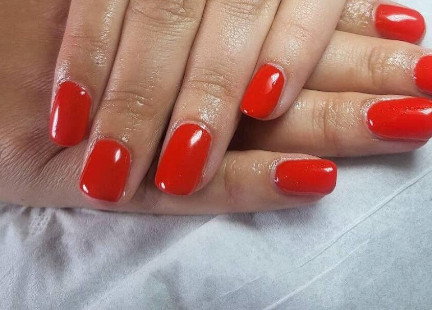 Red manicured nails at Andreas Hands and Tans, Stevenage, England, GB offering premium nail services.