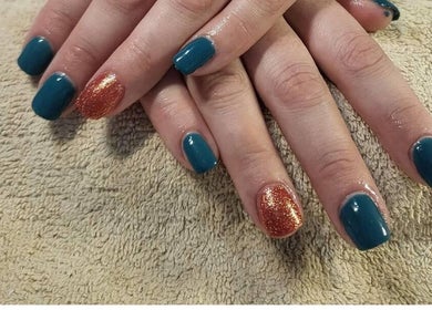 Stylish nails with teal and glitter polish at Andreas Hands and Tans, Stevenage, England, GB.