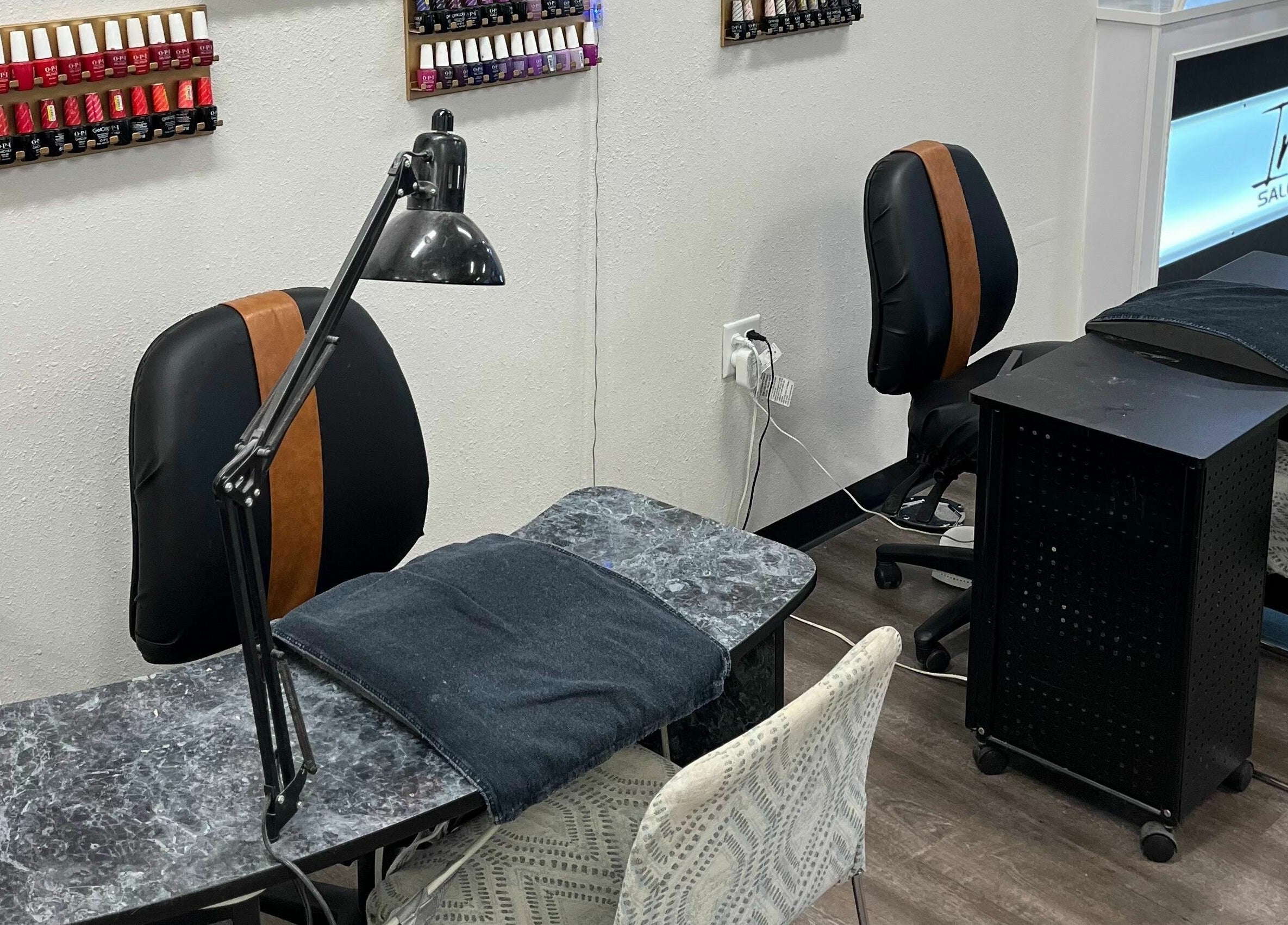 Modern nail stations at Infinity Salon and Spa, Mitchell, South Dakota, US, showcasing diverse polish selection.