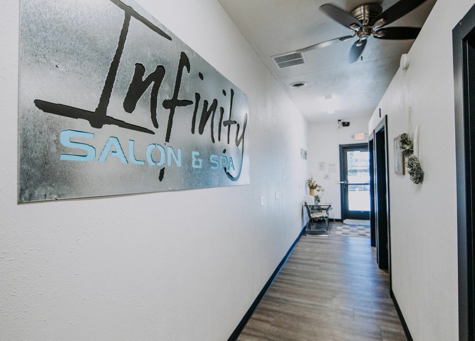 Entrance hallway of Infinity Salon and Spa in Mitchell, South Dakota, US, featuring a modern aesthetic.