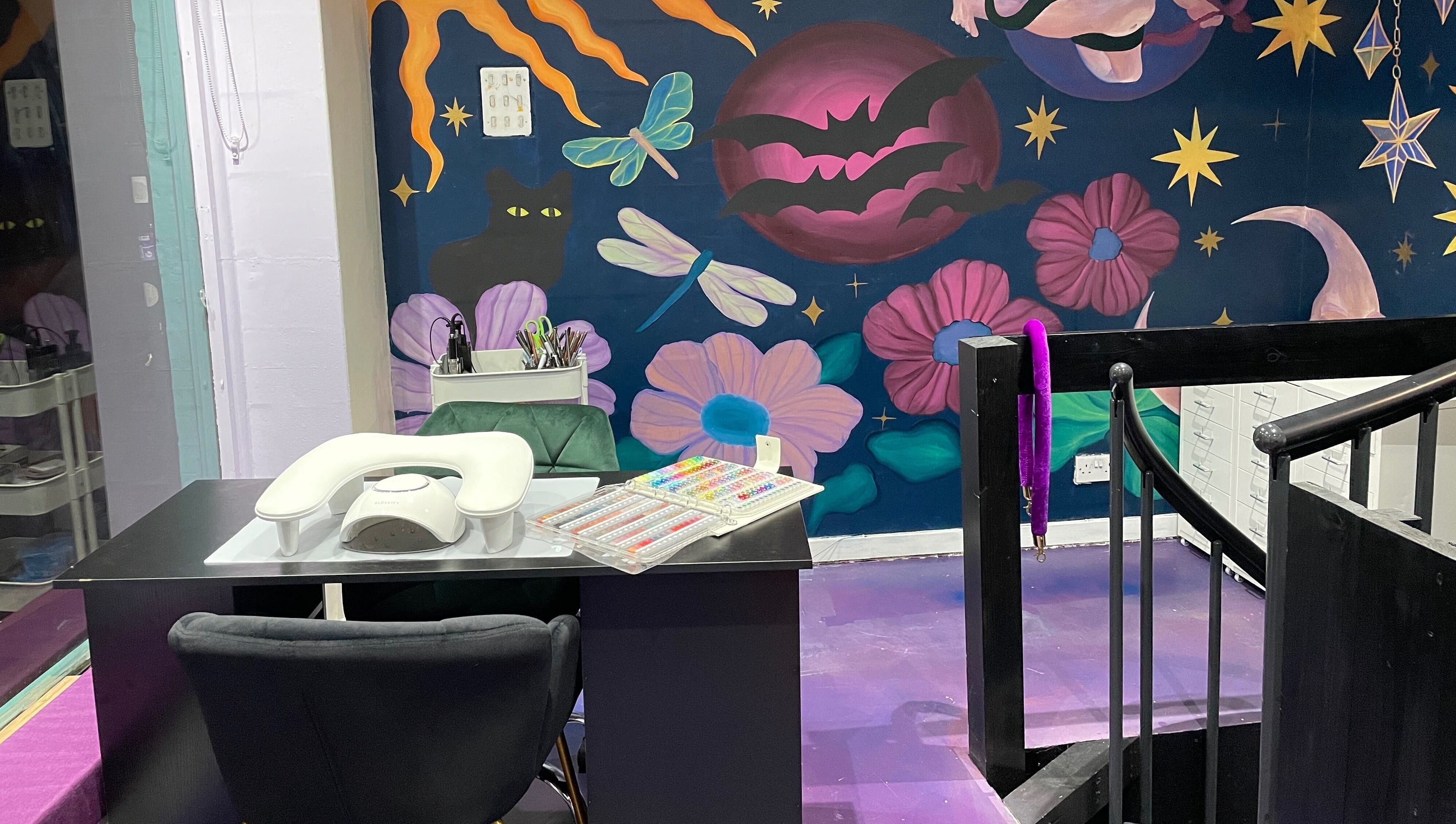 Nail station at Go Coiff Yourself in Brighton And Hove, England, GB with cosmic-themed mural.