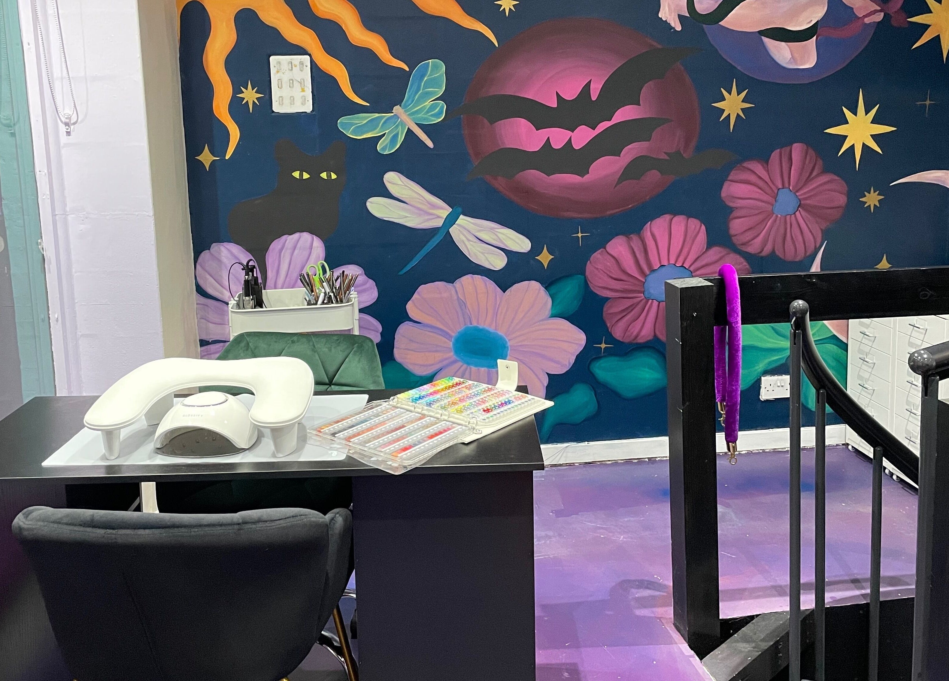 Nail station at Go Coiff Yourself in Brighton And Hove, England, GB with cosmic-themed mural.