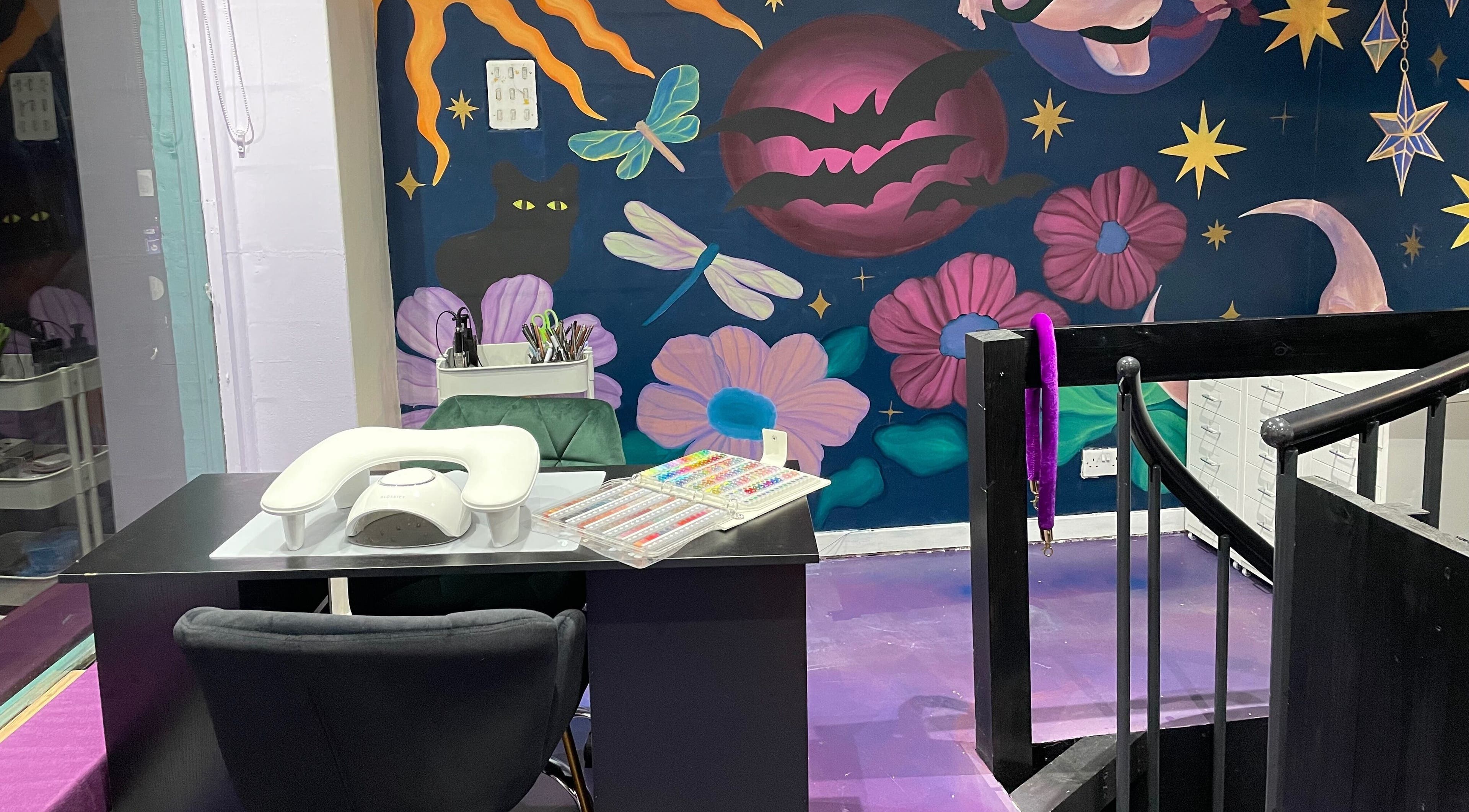 Nail station at Go Coiff Yourself in Brighton And Hove, England, GB with cosmic-themed mural.