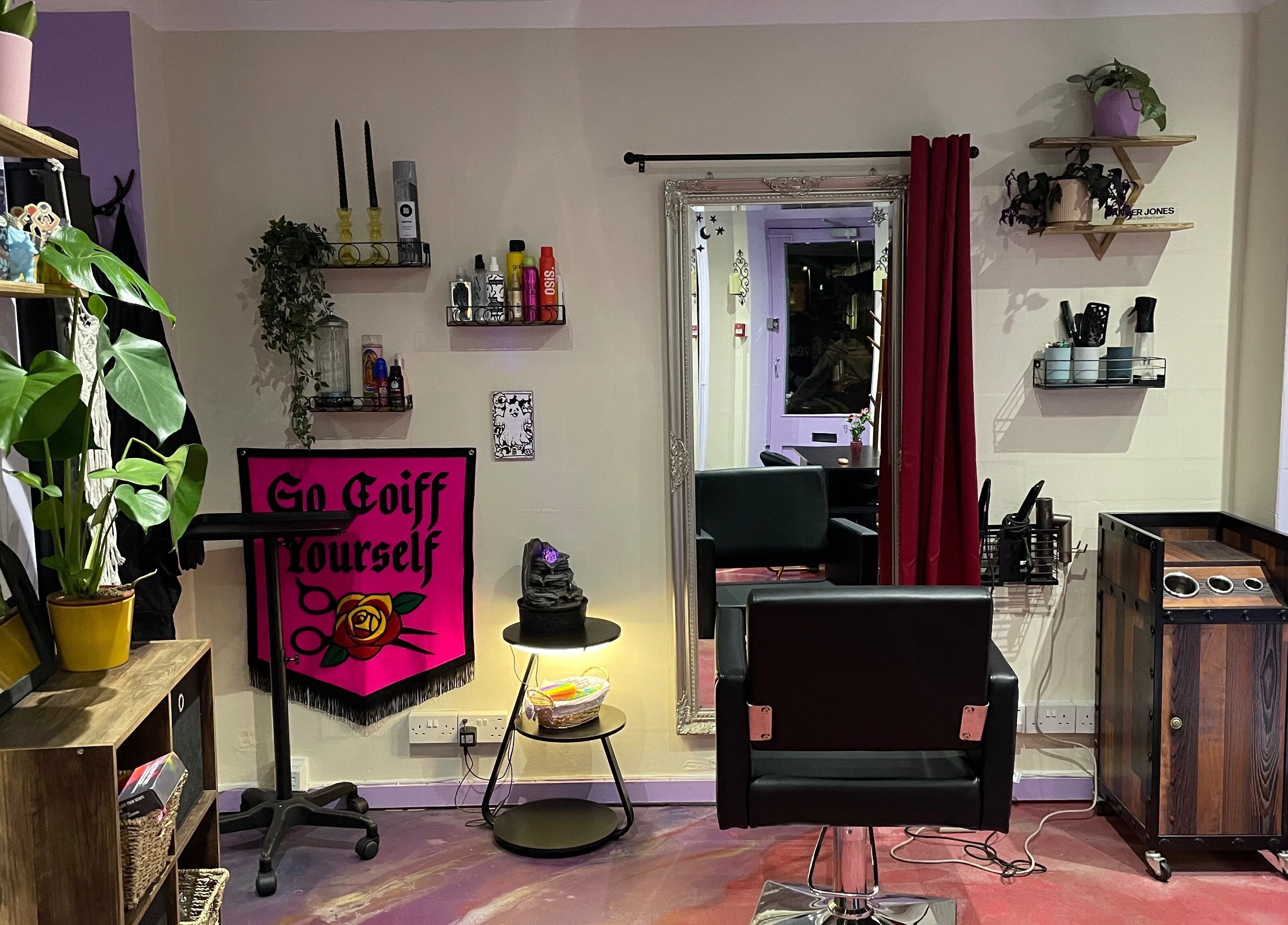 Modern salon interior at Go Coiff Yourself in Brighton And Hove, England, GB. Stylish decor with plants and seating.