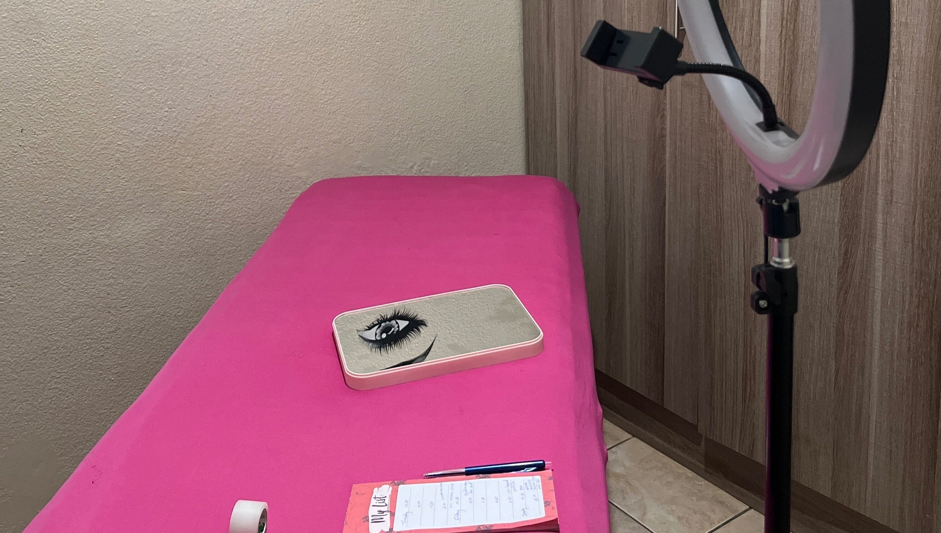 Cozy lash extension setup at LashesBycoley in Kempton Park, Gauteng, ZA featuring a pink bed and ring light.