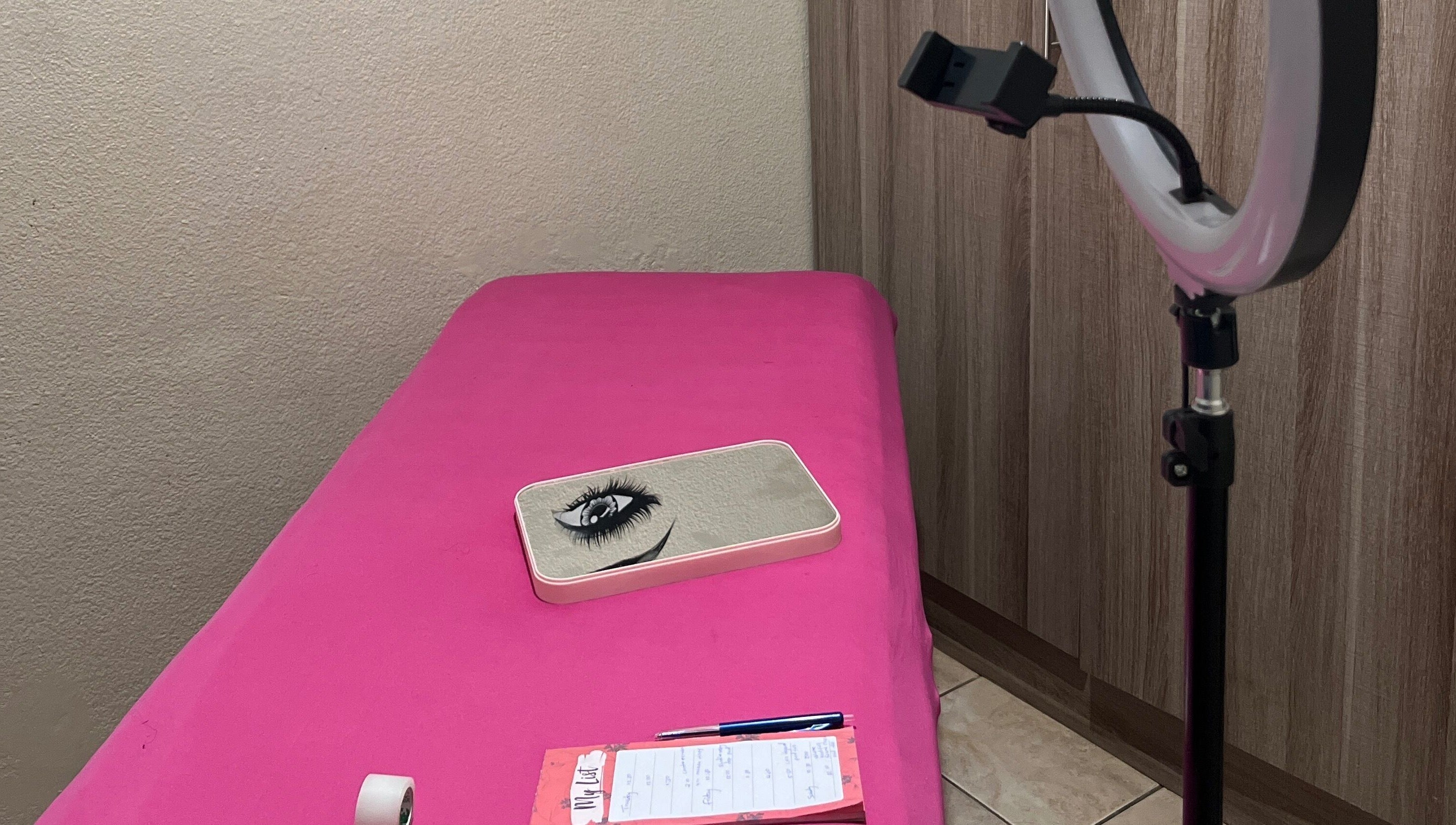 Cozy lash extension setup at LashesBycoley in Kempton Park, Gauteng, ZA featuring a pink bed and ring light.