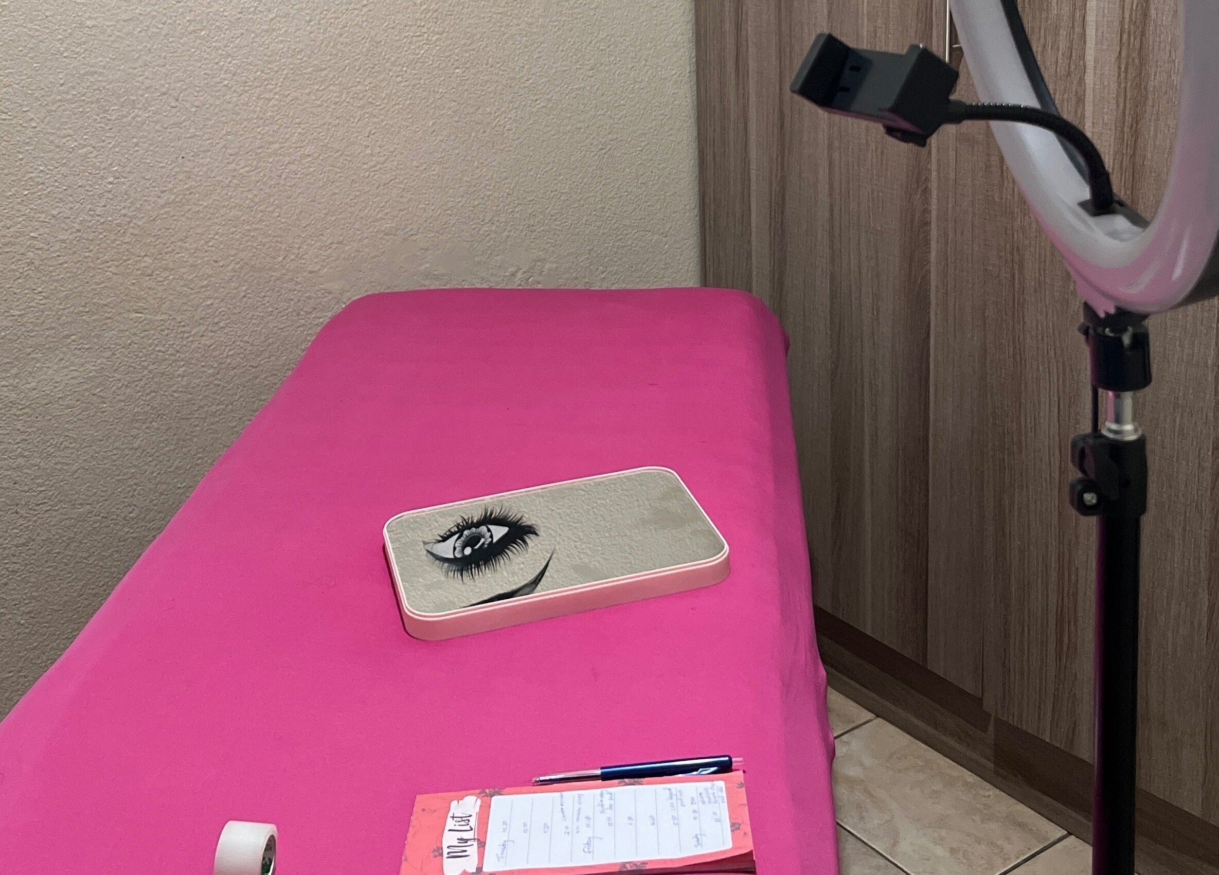 Cozy lash extension setup at LashesBycoley in Kempton Park, Gauteng, ZA featuring a pink bed and ring light.