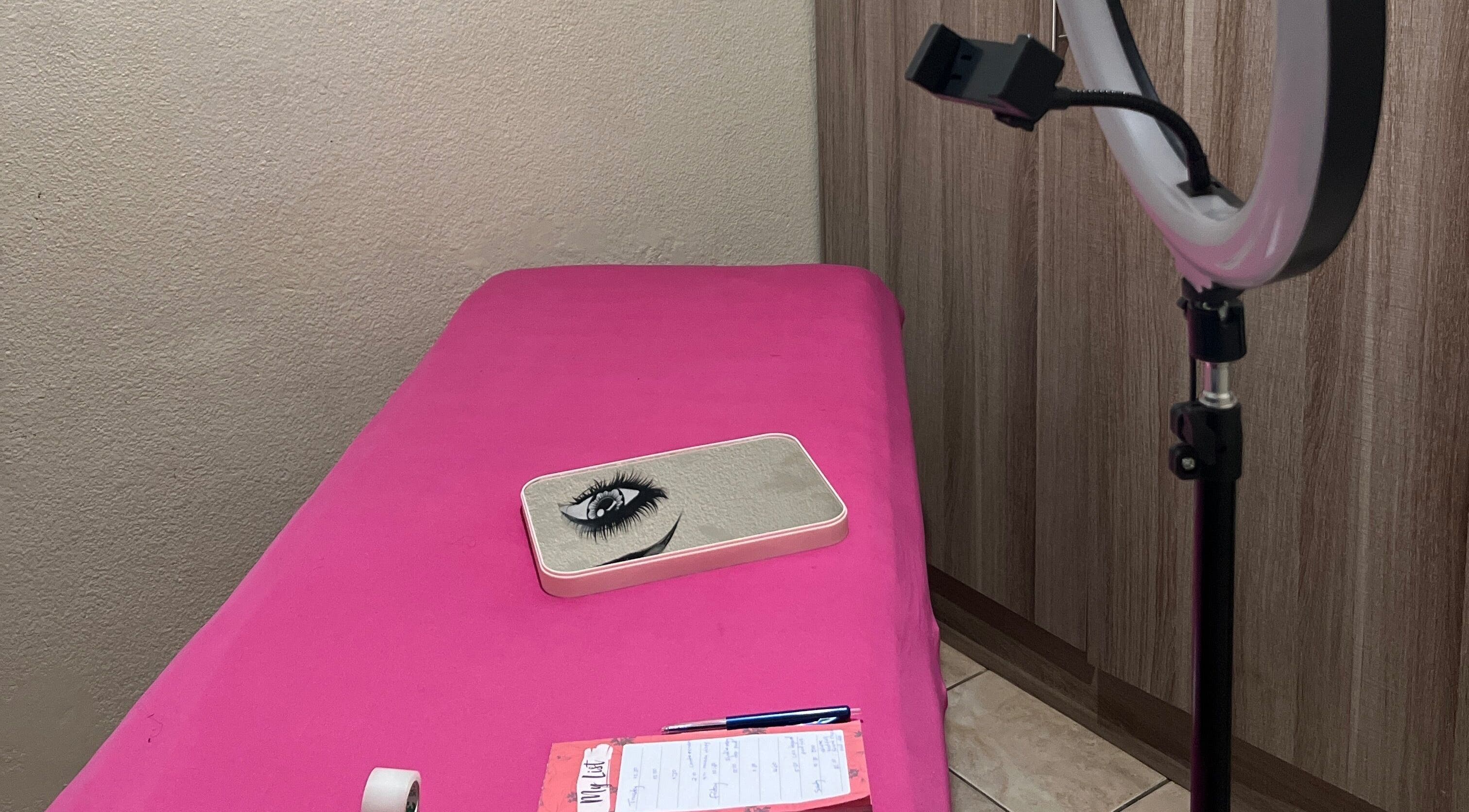 Cozy lash extension setup at LashesBycoley in Kempton Park, Gauteng, ZA featuring a pink bed and ring light.